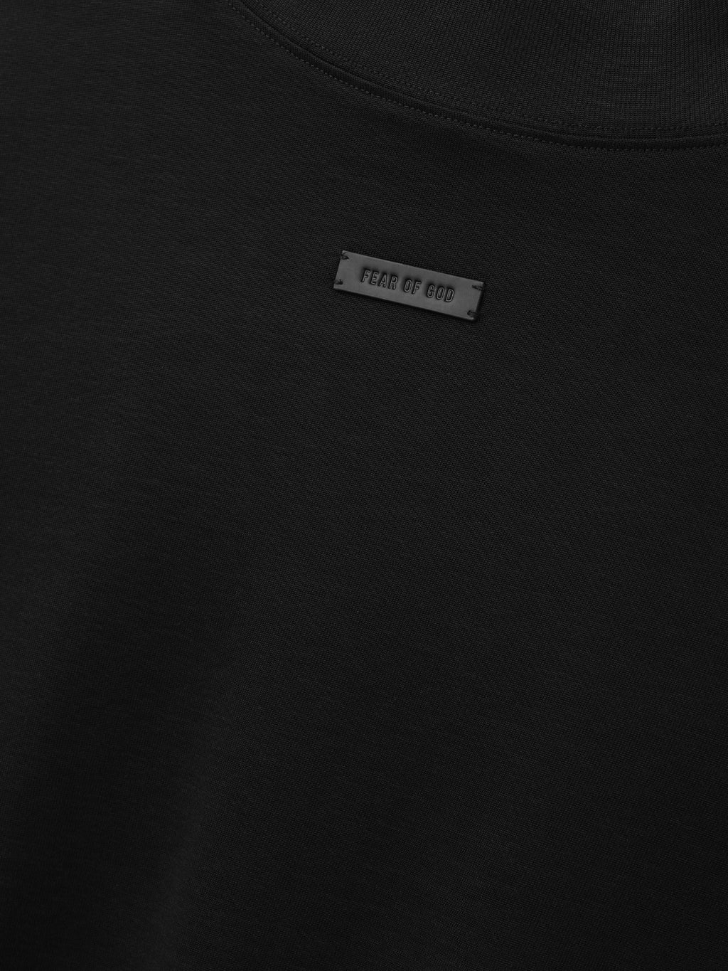 Cotton Rayon Mockneck Long Sleeve Tee in black shown in close detail with smooth fabric mockneck collar and Fear of God label as Tops