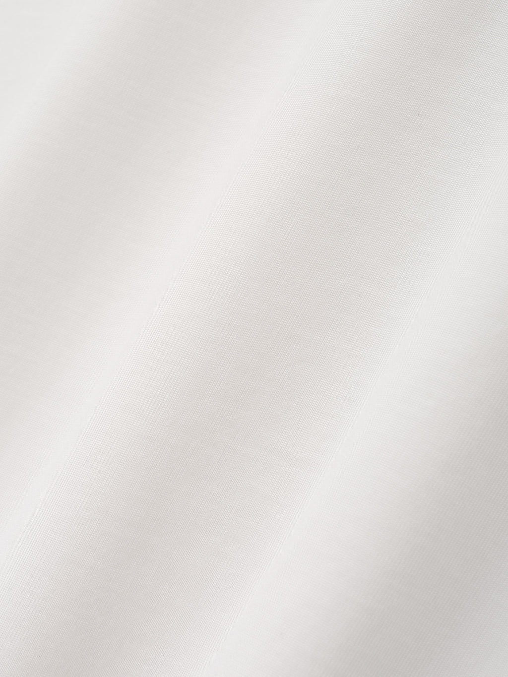 Cotton Rayon Eternal Tee in off white shown in close detail with soft smooth fabric texture and subtle folds as Tops