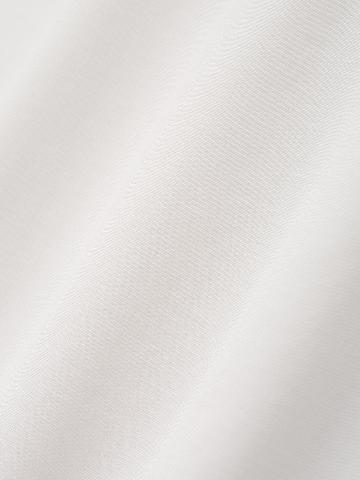 Cotton Rayon Eternal Tee in off white shown in close detail with soft smooth fabric texture and subtle folds as Tops
