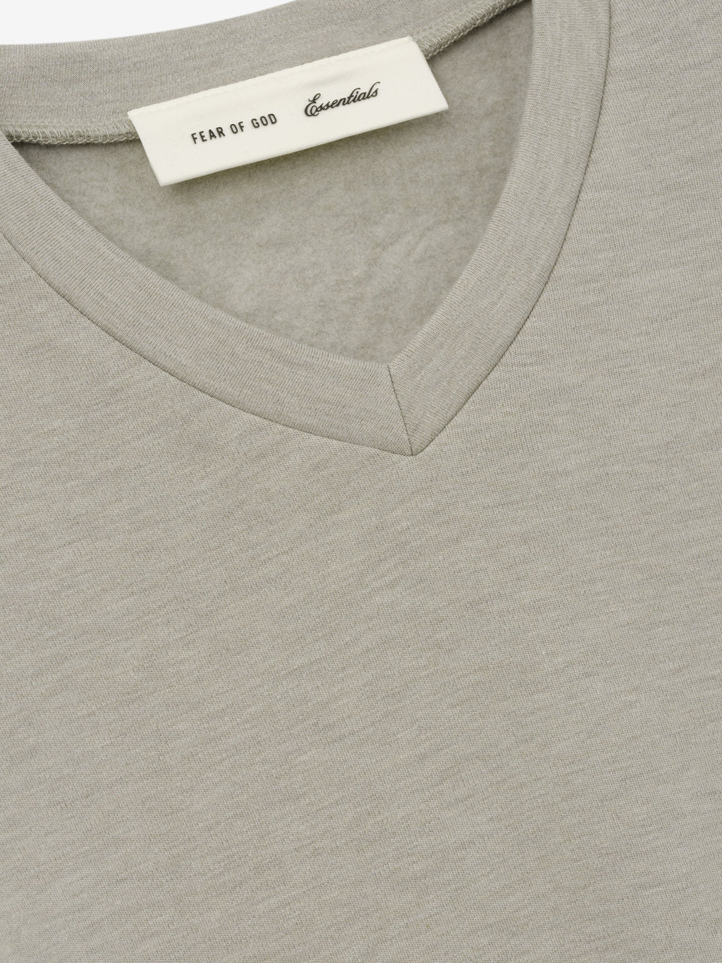 Womens Longsleeve V-Neck in light grey close up showing the V neckline fine fabric texture and Fear of God Essentials label as Tops
