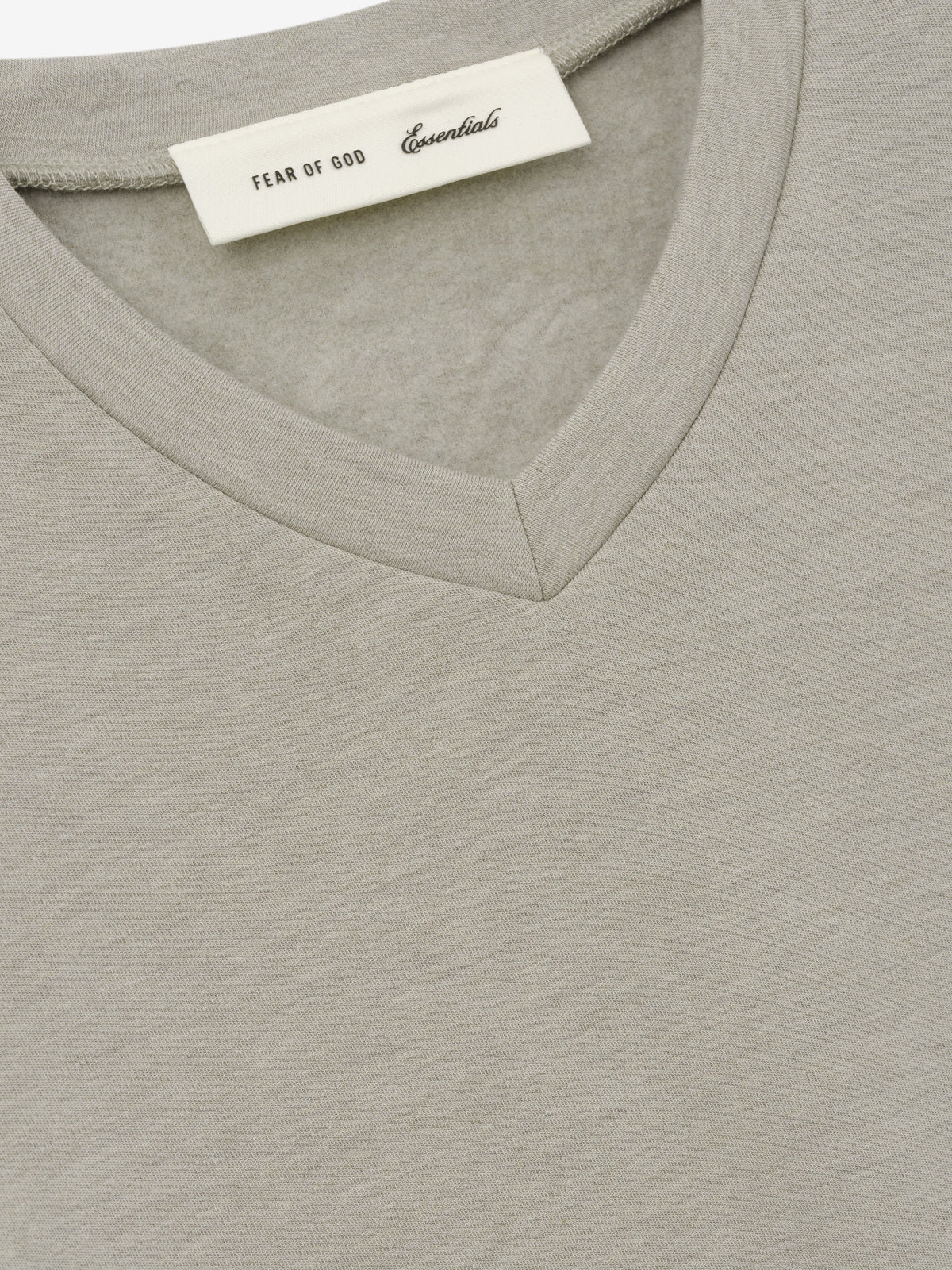 Womens Longsleeve V-Neck in light grey close up showing the V neckline fine fabric texture and Fear of God Essentials label as Tops