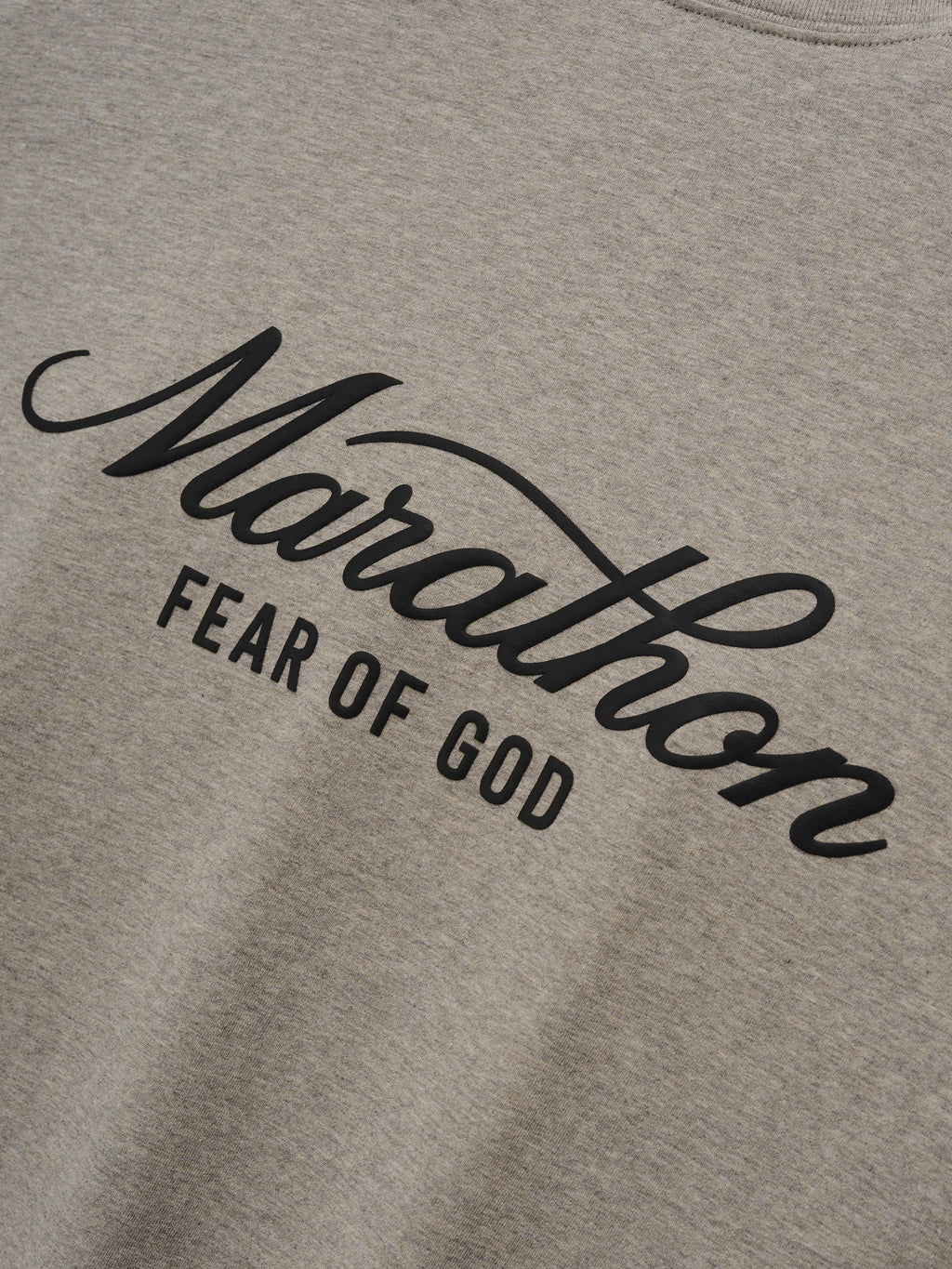 Marathon Merch Tee in heather gray featuring bold black Marathon Fear of God script branding across the chest on soft jersey fabric as Tops