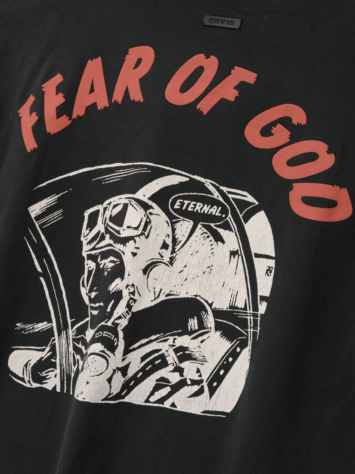 Flight Tee in black with red Fear of God lettering and a white astronaut illustration with an Eternal helmet shown in close detail as Tops