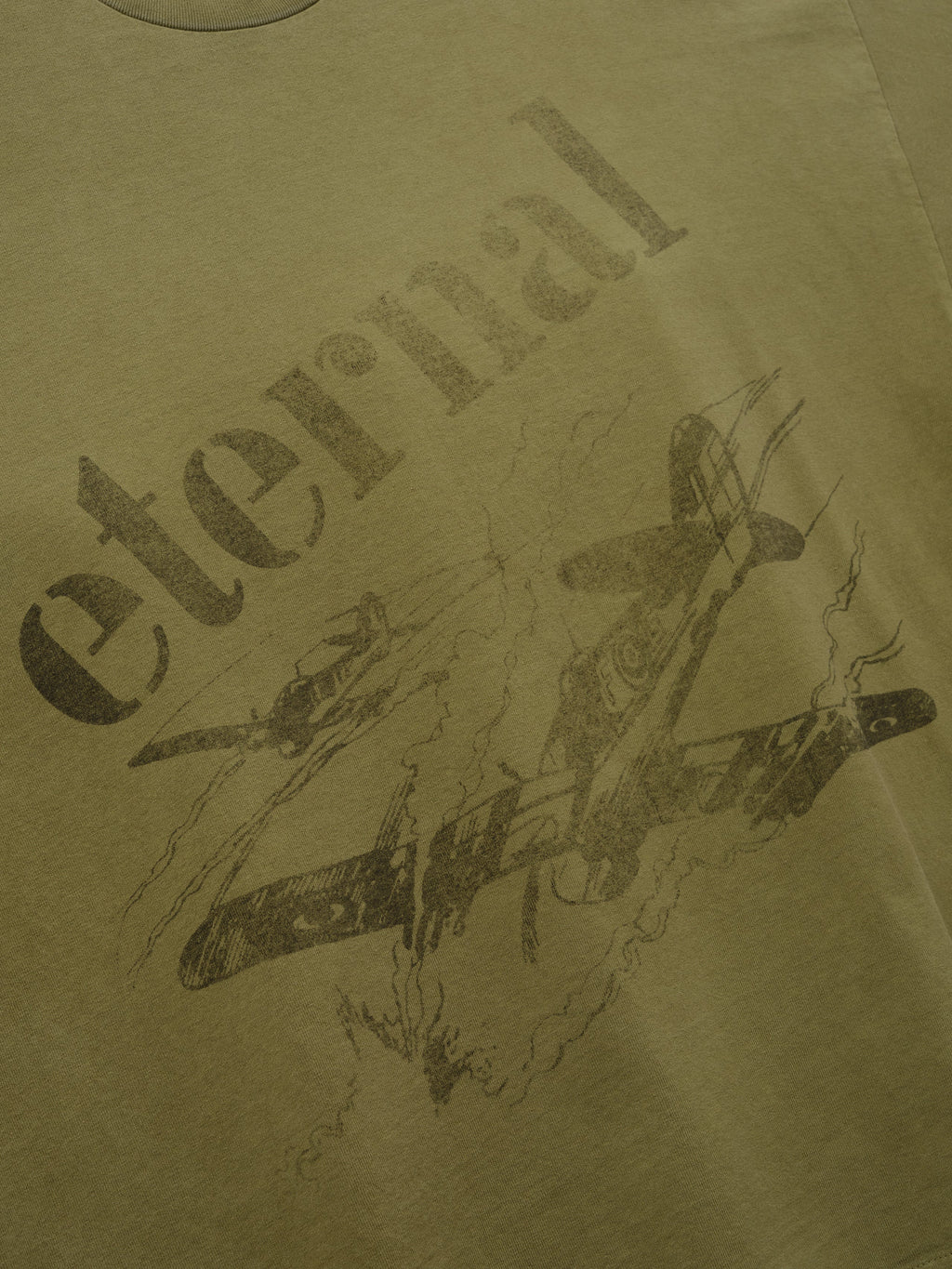 Flight Tee in olive green with tonal Eternal lettering and a vintage aircraft illustration across the front shown in close detail as Tops