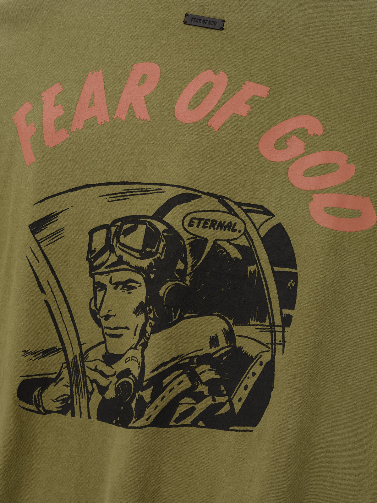 Flight Tee in olive green with pink Fear of God lettering and a vintage pilot illustration wearing an Eternal helmet across the front shown in close detail as Tops