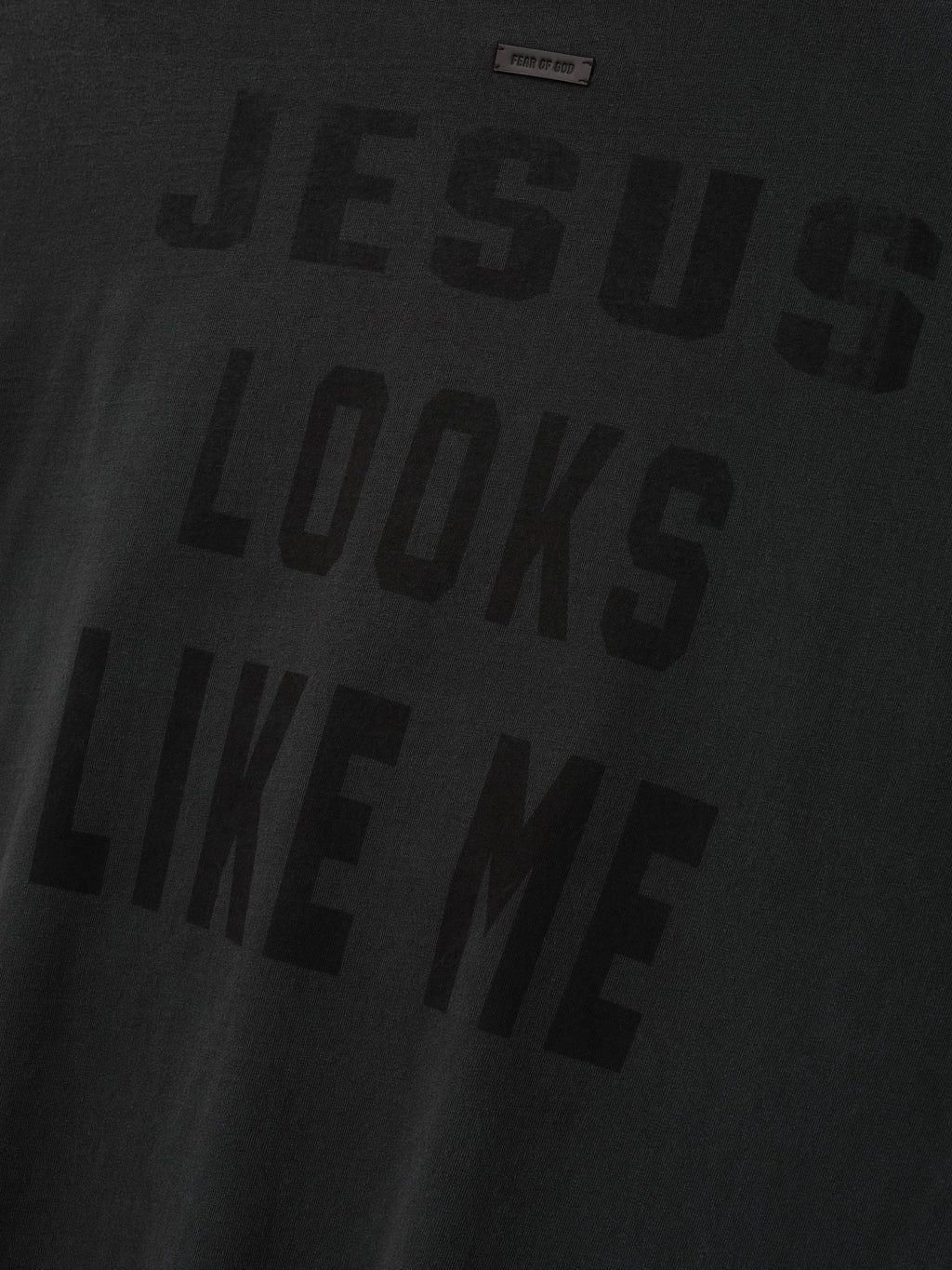 Cross Long Sleeve Tee in black with tonal JESUS LOOKS LIKE ME lettering across the front and a subtle Fear of God label shown in close detail as Tops