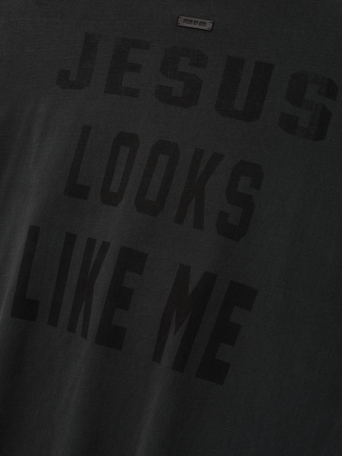 Cross Long Sleeve Tee in black with tonal JESUS LOOKS LIKE ME lettering across the front and a subtle Fear of God label shown in close detail as Tops