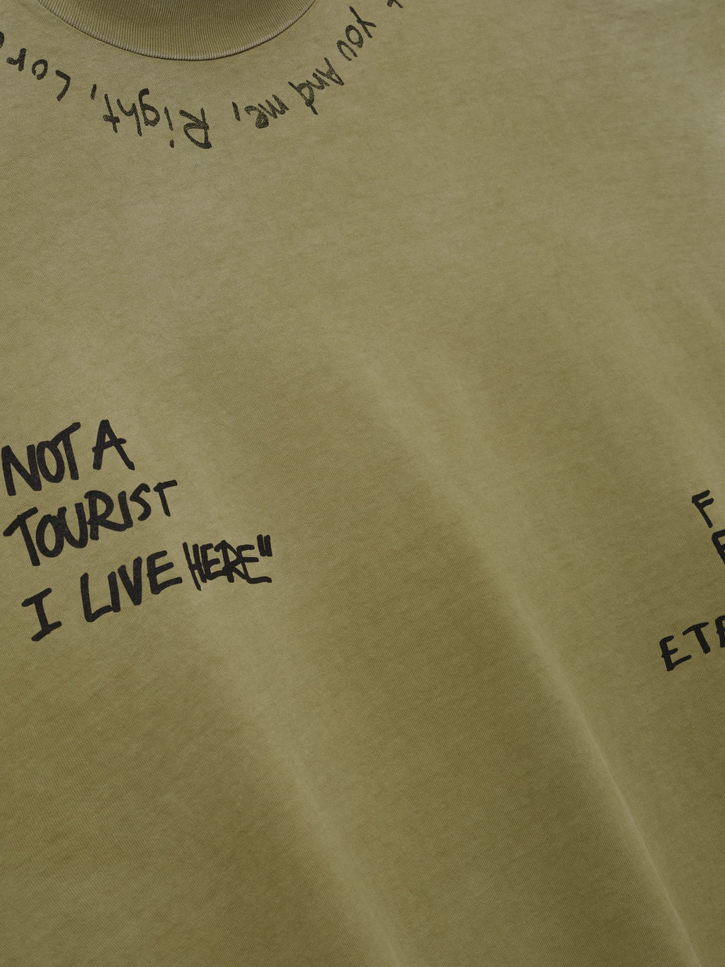 Hand Written Mockneck Long Sleeve Tee in olive green with black handwritten graphics including NOT A TOURIST I LIVE HERE shown in close detail as Tops