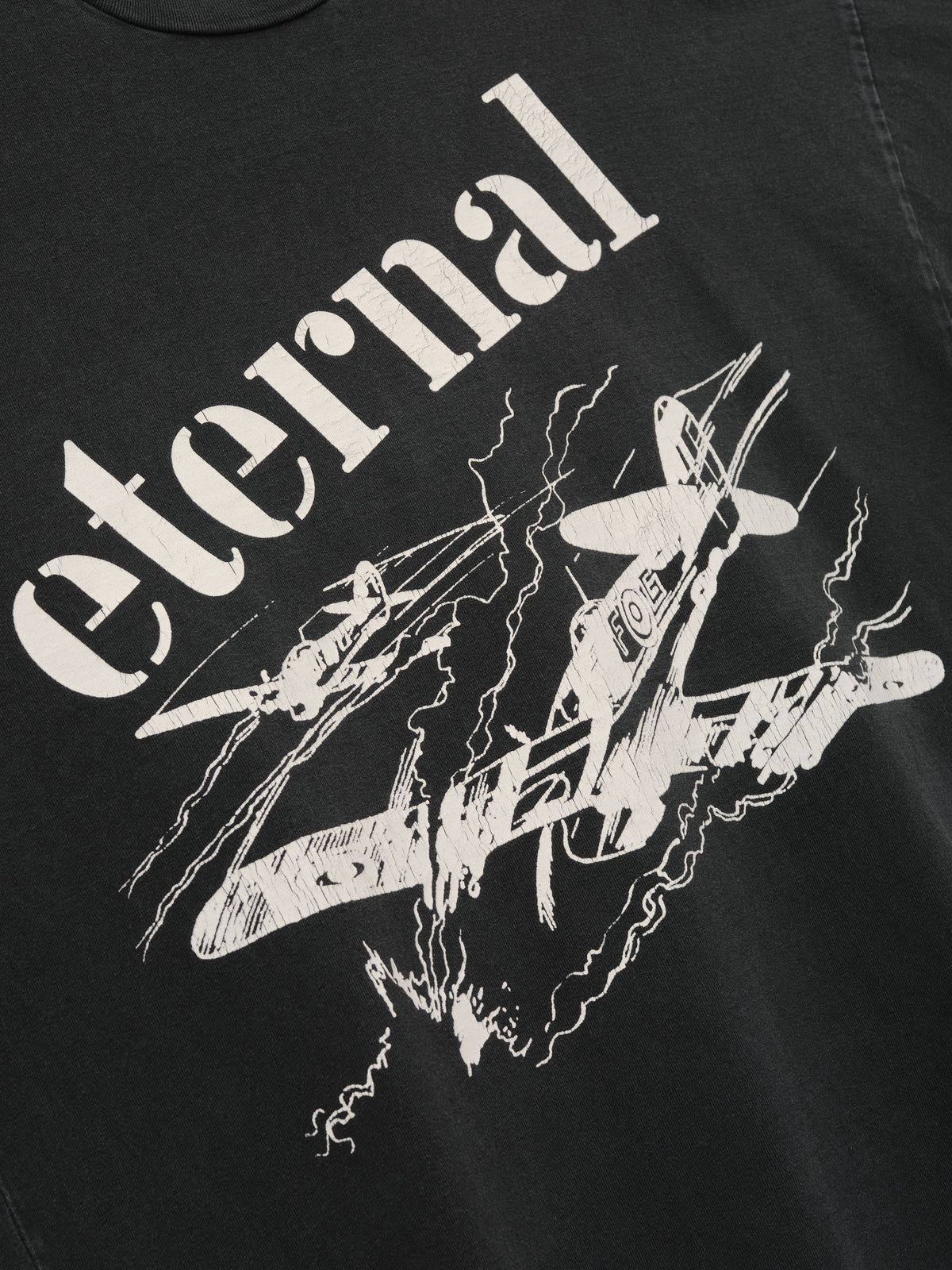 Flight Long Sleeve Tee in black with cream Eternal lettering and aircraft artwork surrounded by lightning graphics shown in close detail as Tops