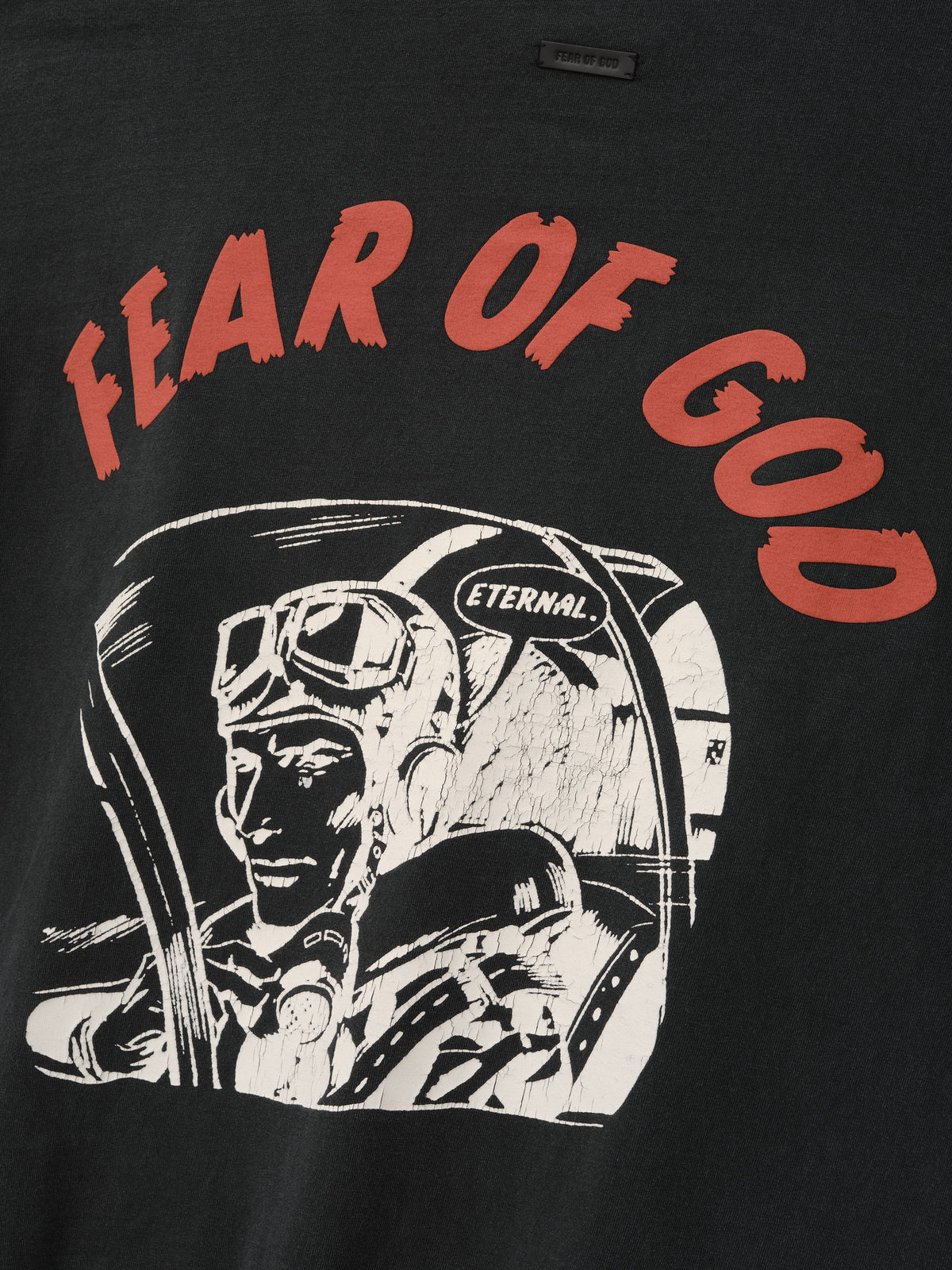 Flight Long Sleeve Tee in black with red Fear of God lettering and white vintage astronaut cockpit artwork shown in close detail as Tops