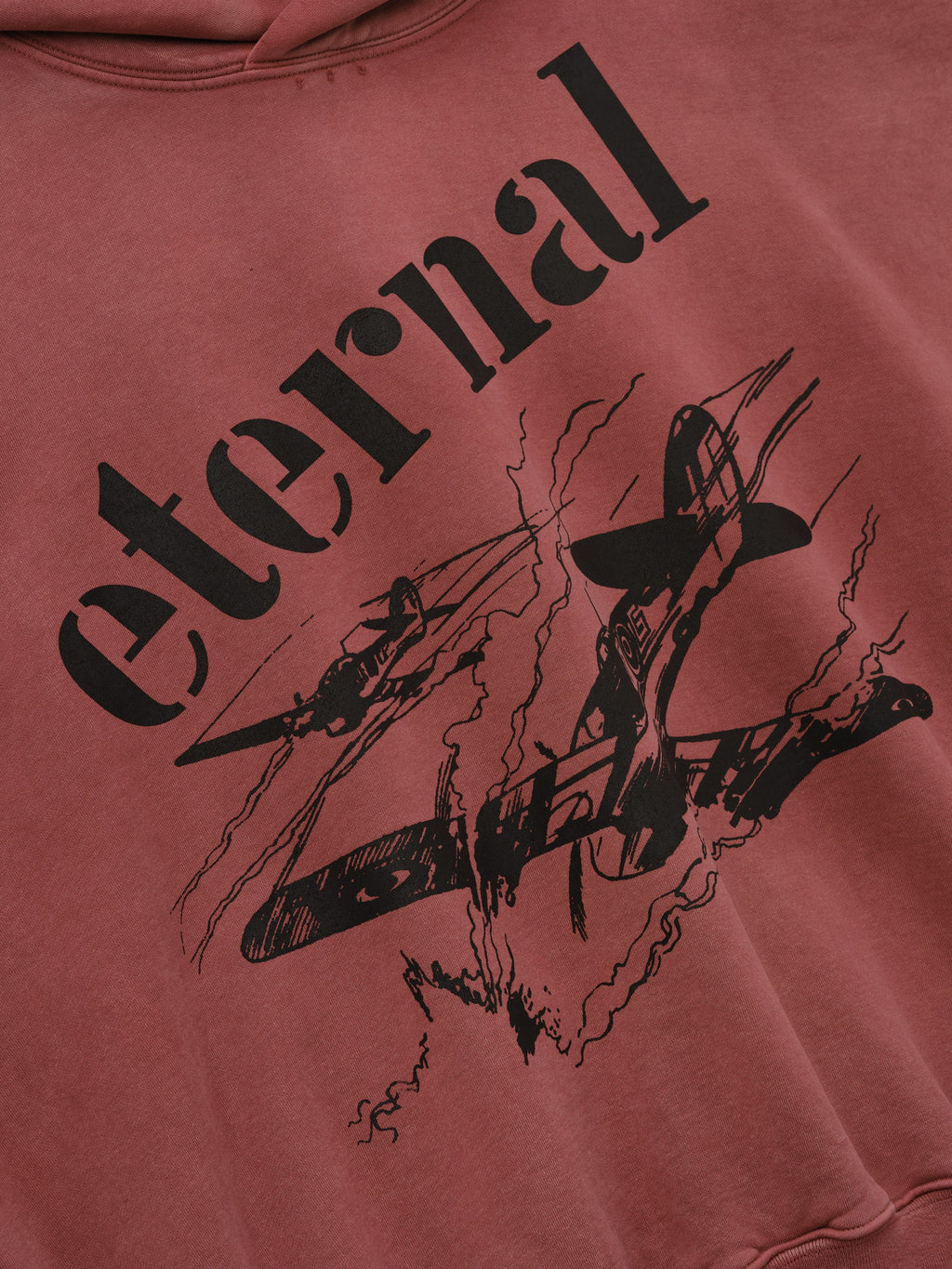 Flight Hoodie in faded burgundy with black Eternal lettering and vintage aircraft artwork shown in close detail as Tops