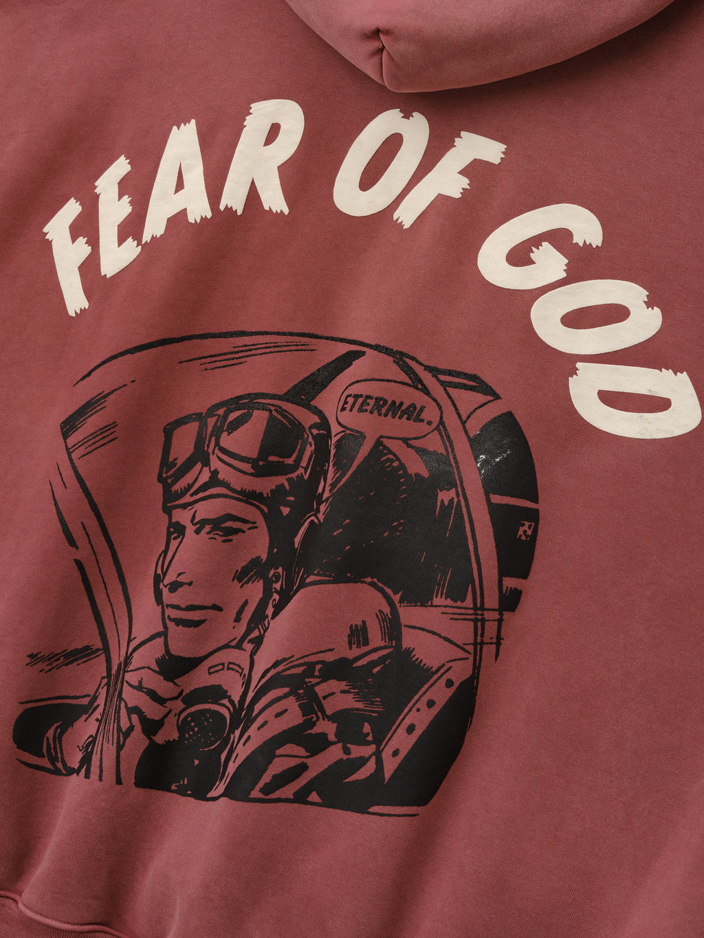 Flight Hoodie in faded burgundy with cream Fear of God lettering and black vintage astronaut flight graphic shown in close detail as Tops