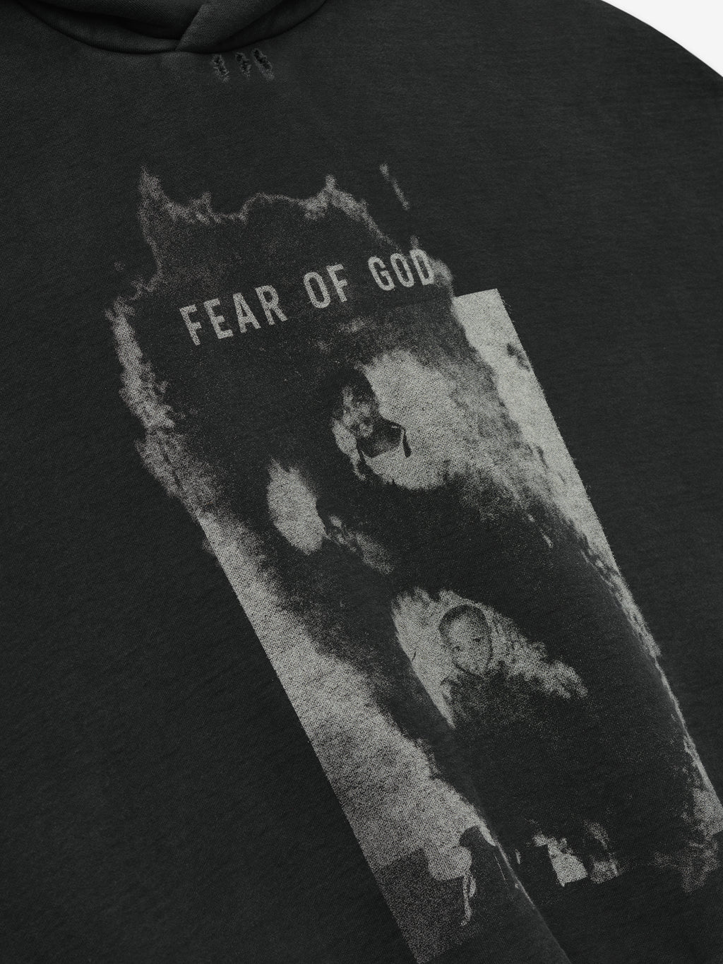 dark charcoal cotton fleece hoodie with distressed black-and-white graphic and Fear of God text on front panel