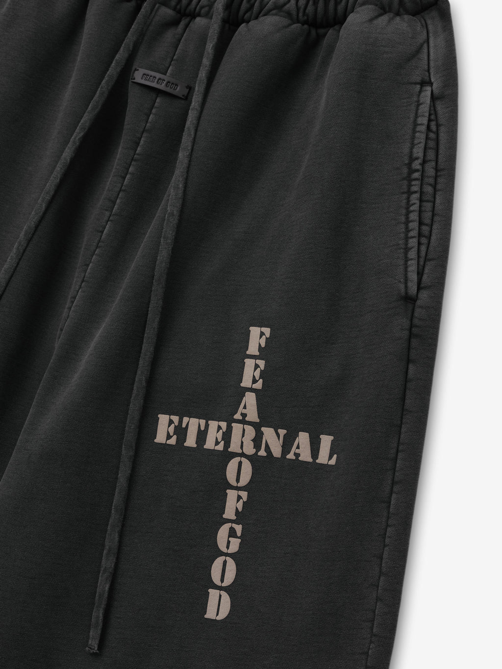 Cross Wide Leg Sweatpants in black close-up with drawcord waist side pocket and vertical Fear of God Eternal branding as Bottoms