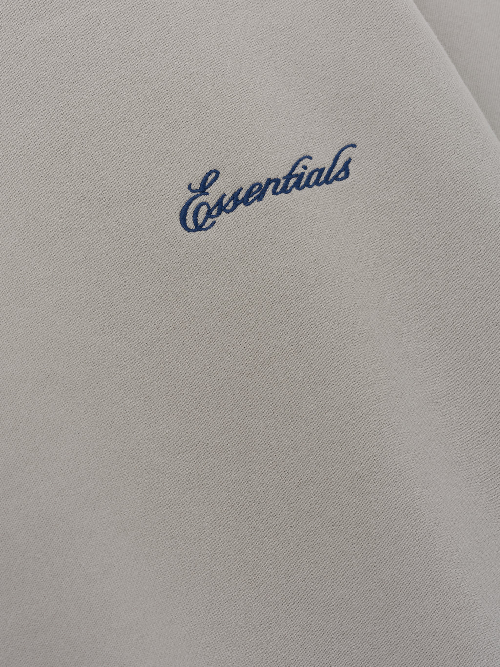 Signature Lounge Crewneck Sweatshirt in taupe close up showing navy Essentials script embroidery on soft textured fabric displayed as Tops