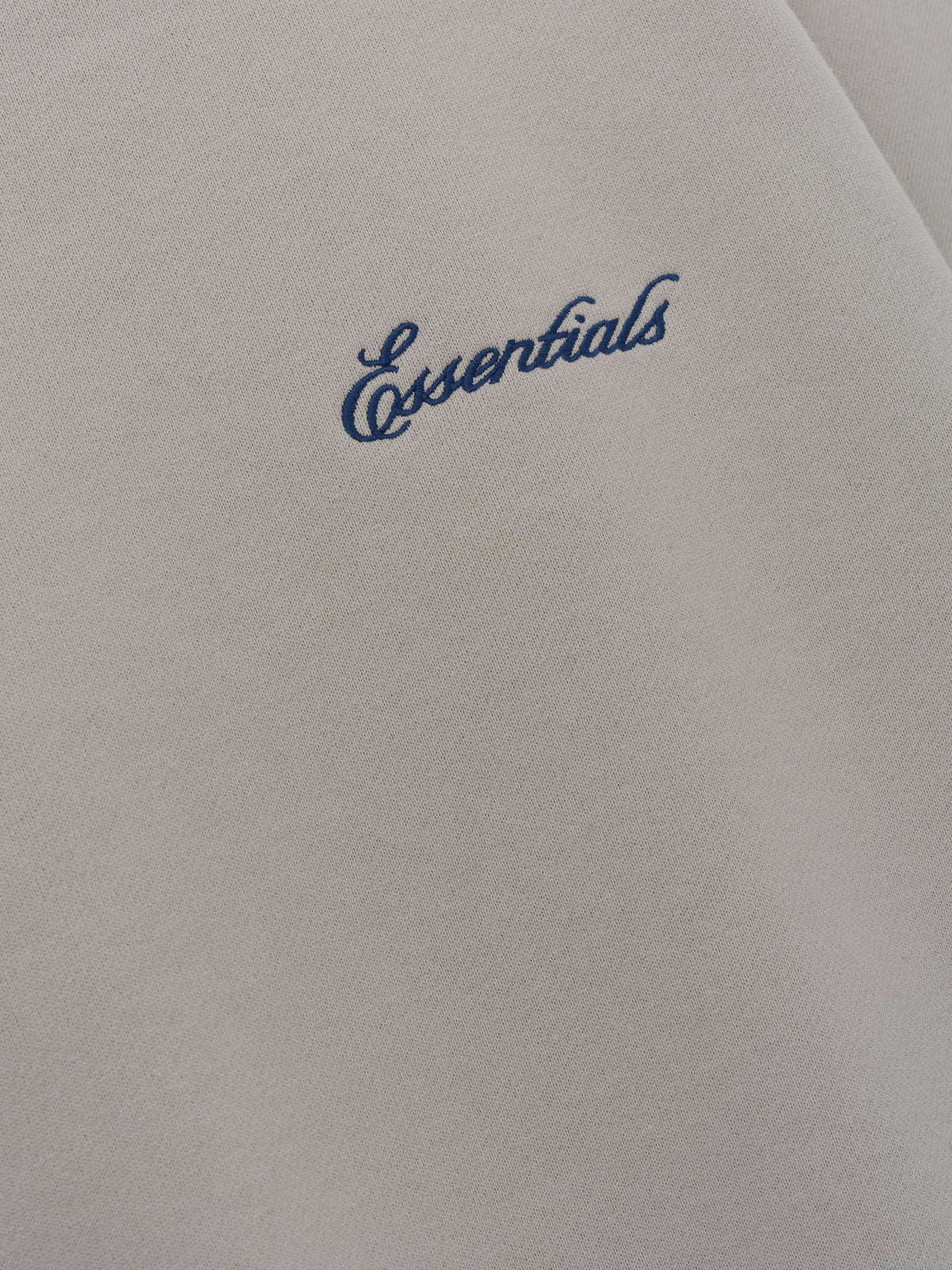 Signature Lounge Crewneck Sweatshirt in taupe close up showing navy Essentials script embroidery on soft textured fabric displayed as Tops