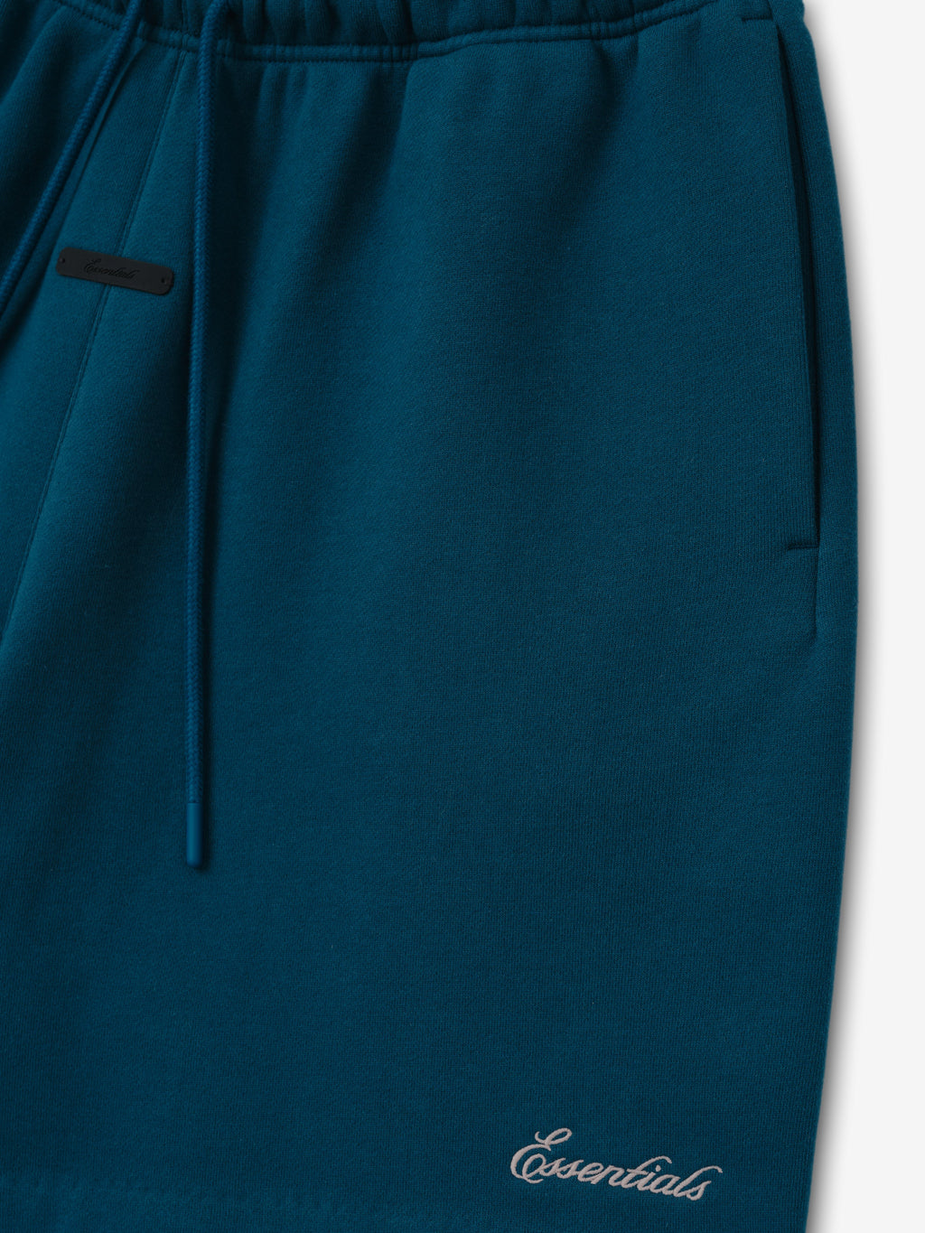 Signature Classic Short in deep teal with an elastic drawstring waistband side pocket and subtle Essentials script logo displayed as Bottoms