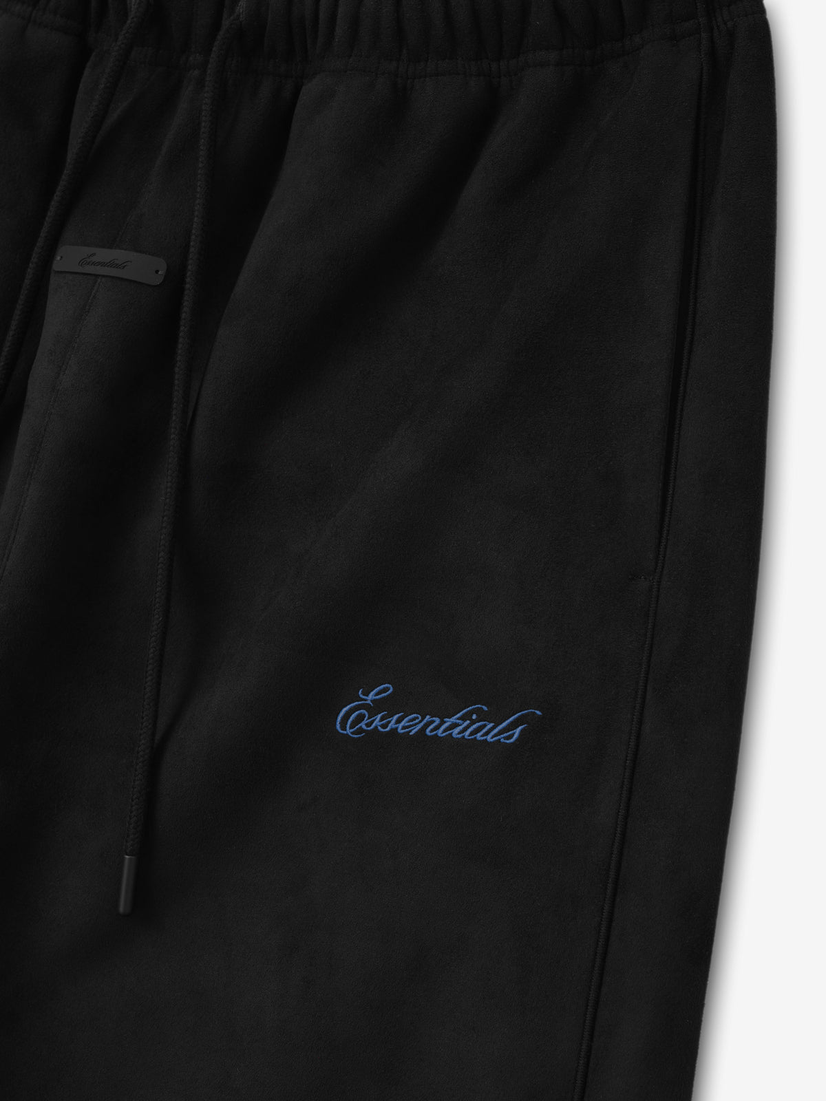 Suede Fleece Signature Relaxed Pant W/ Piping in black featuring a blue Essentials script logo elastic drawstring waist and relaxed straight leg shown as Bottoms