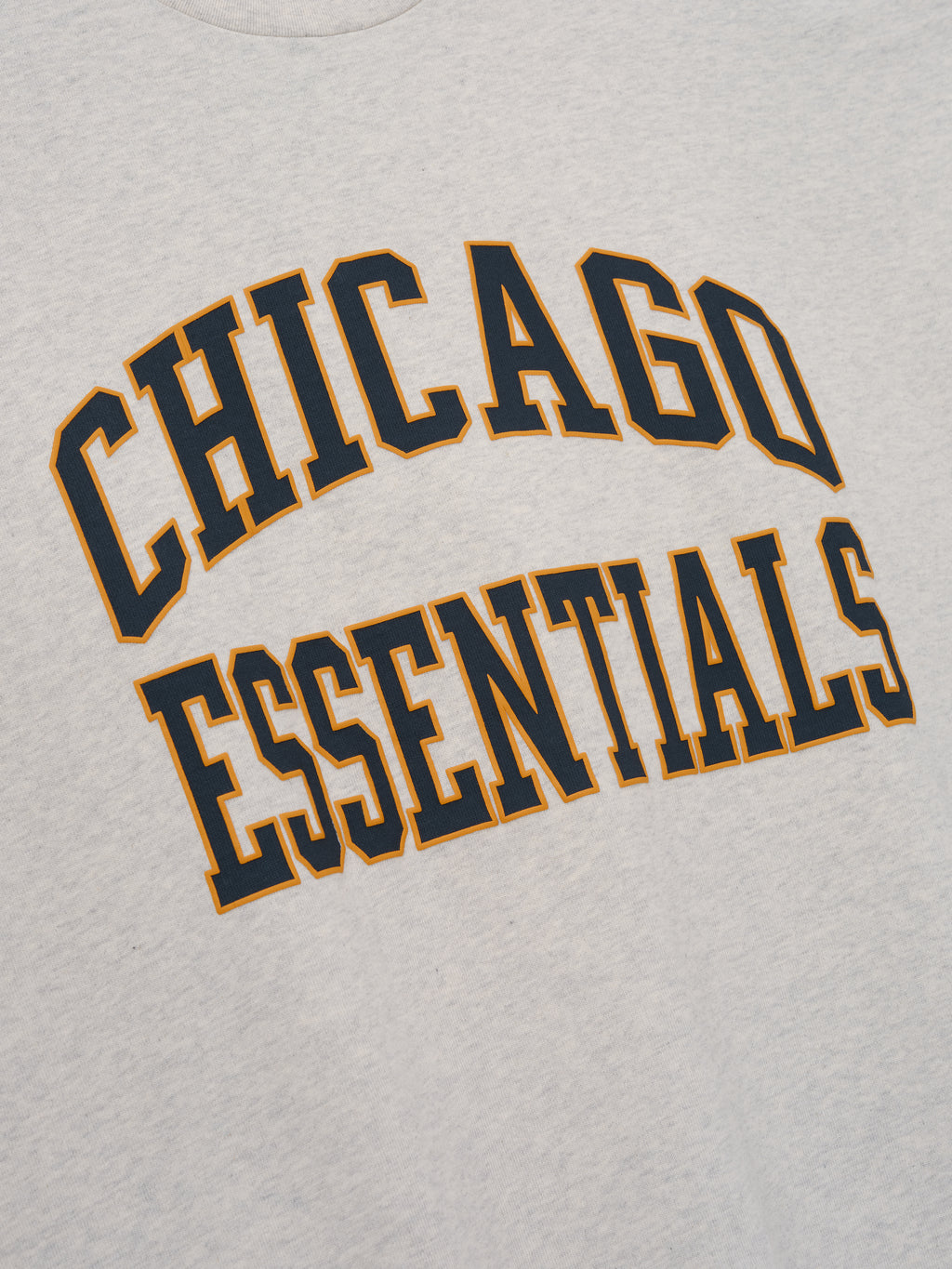 Bears Merch Tee gray fabric close up featuring bold Chicago Essentials collegiate lettering in a detailed Tops product view
