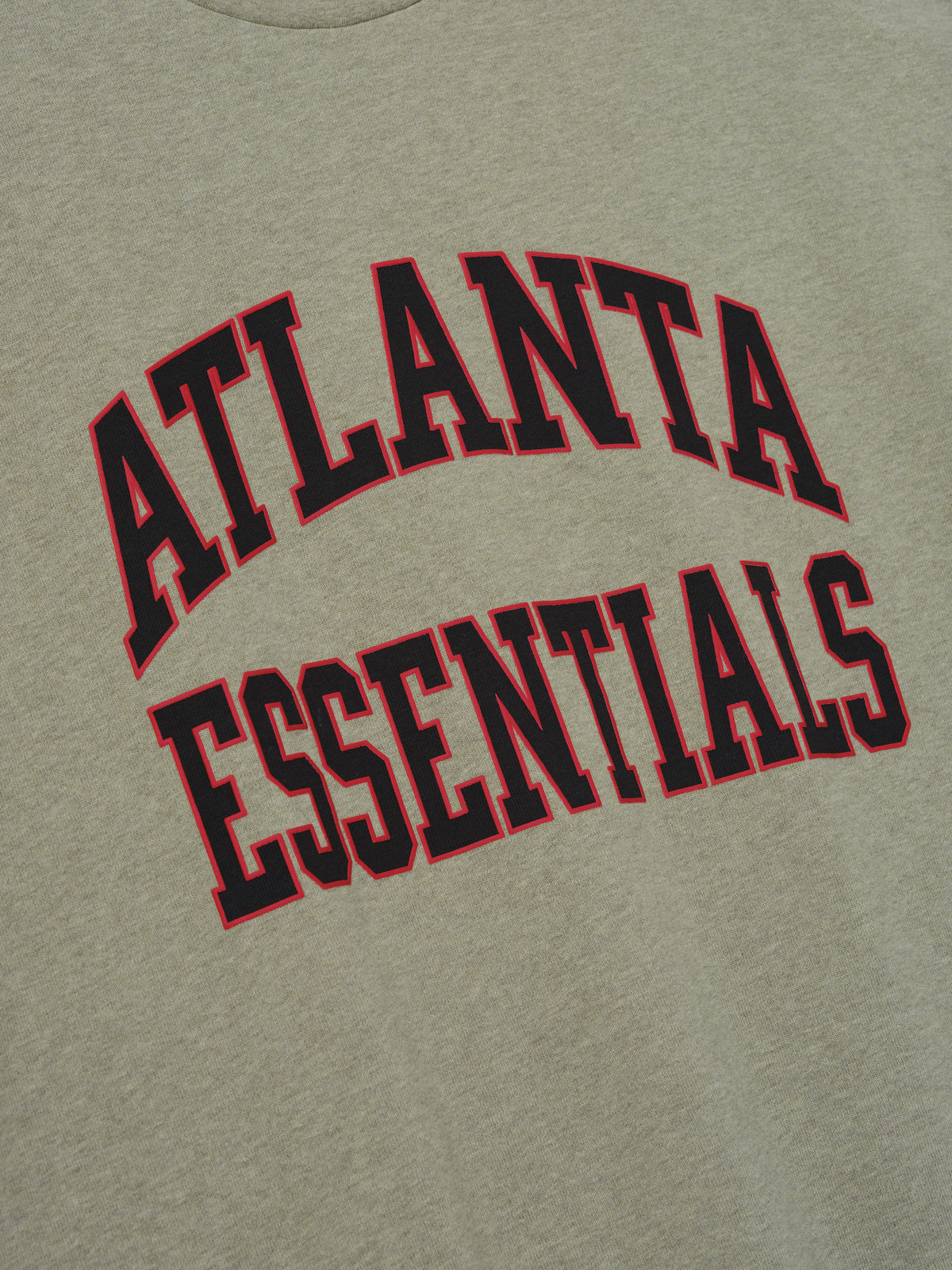Falcons Merch Tee olive green fabric close up featuring bold black Atlanta Essentials lettering outlined in red in a collegiate inspired Tops design