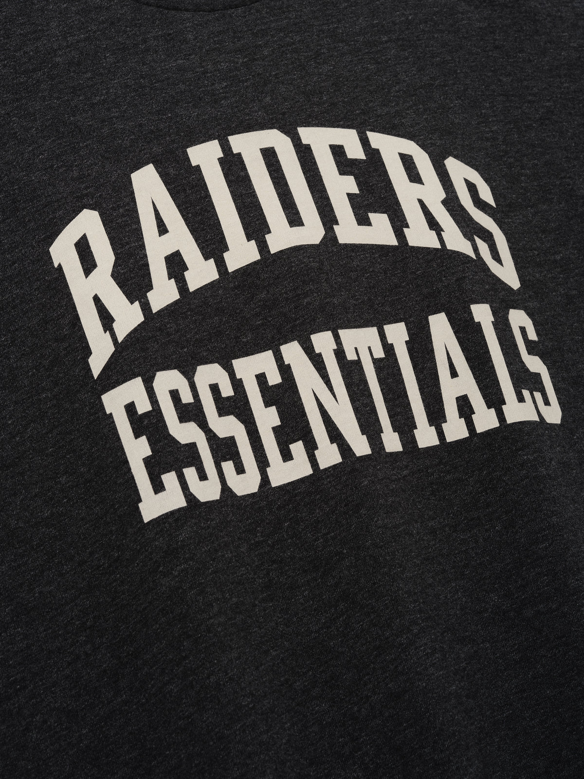 Raiders Merch Tee charcoal fabric close up with bold white Raiders Essentials collegiate lettering in a clean Tops product detail view
