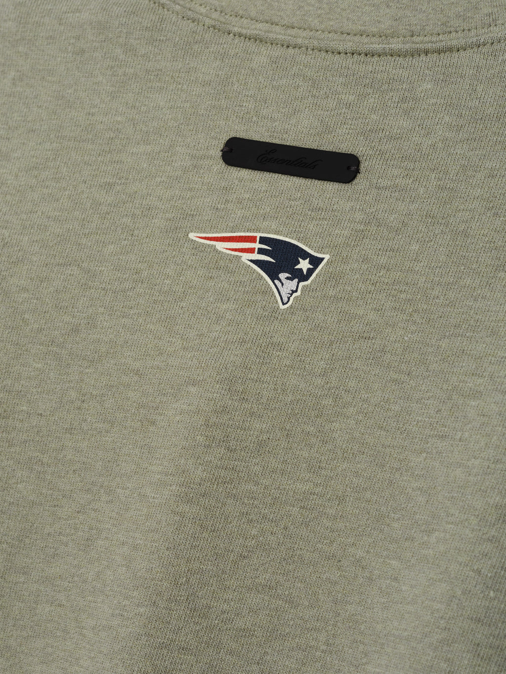 Patriots Merch Tee olive gray fabric close up with a New England Patriots logo and black chest label in a detailed Tops product view