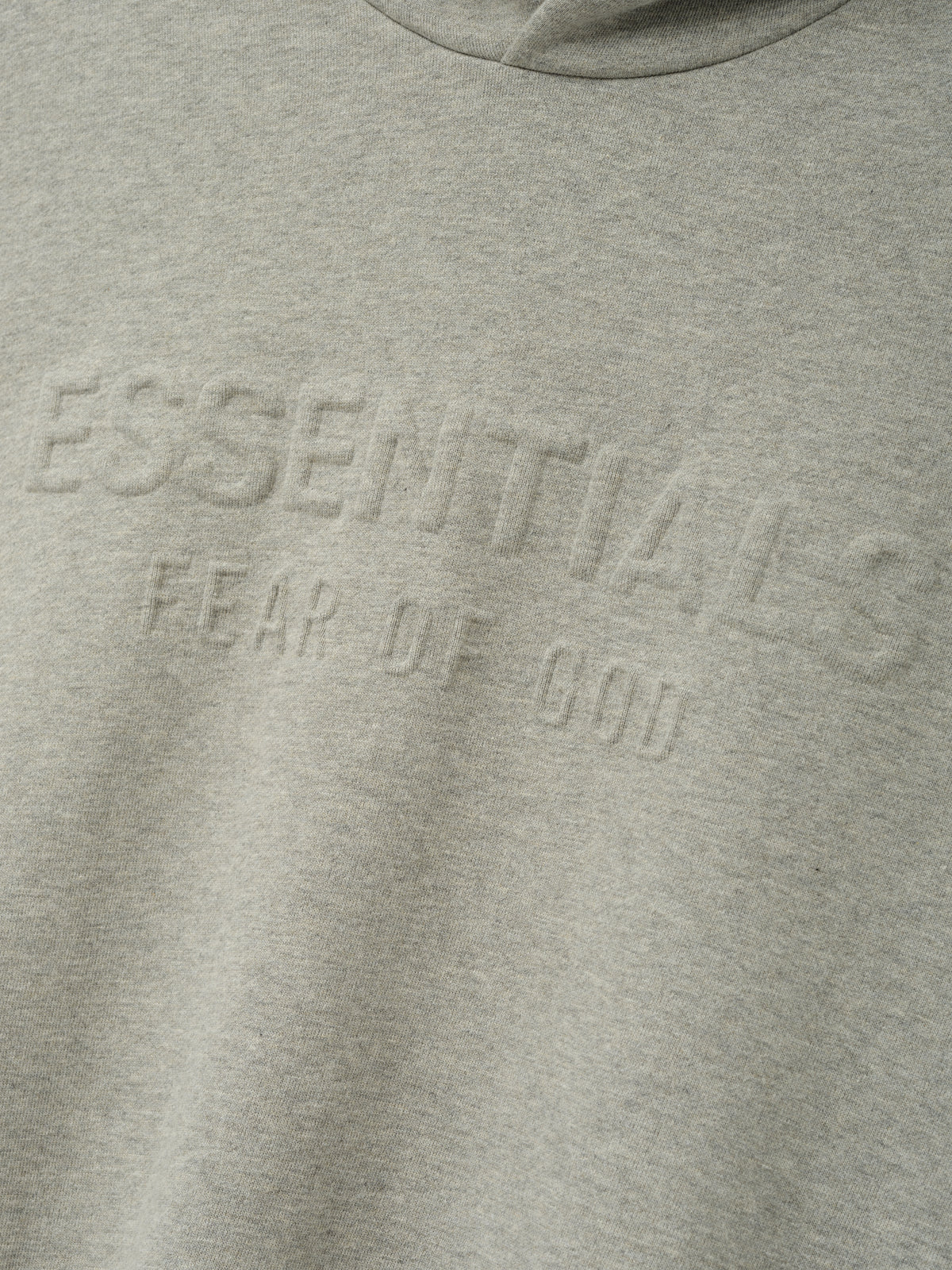 Embossed FW26 90s Relaxed Hoodie in gray with raised tonal chest lettering and a soft fleece texture visible across the front panel