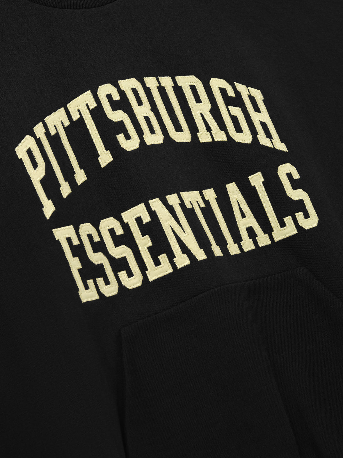 Steelers 90s Relaxed Crewneck black sweatshirt featuring cream Pittsburgh Essentials collegiate lettering and kangaroo pocket shown as a Tops product detail