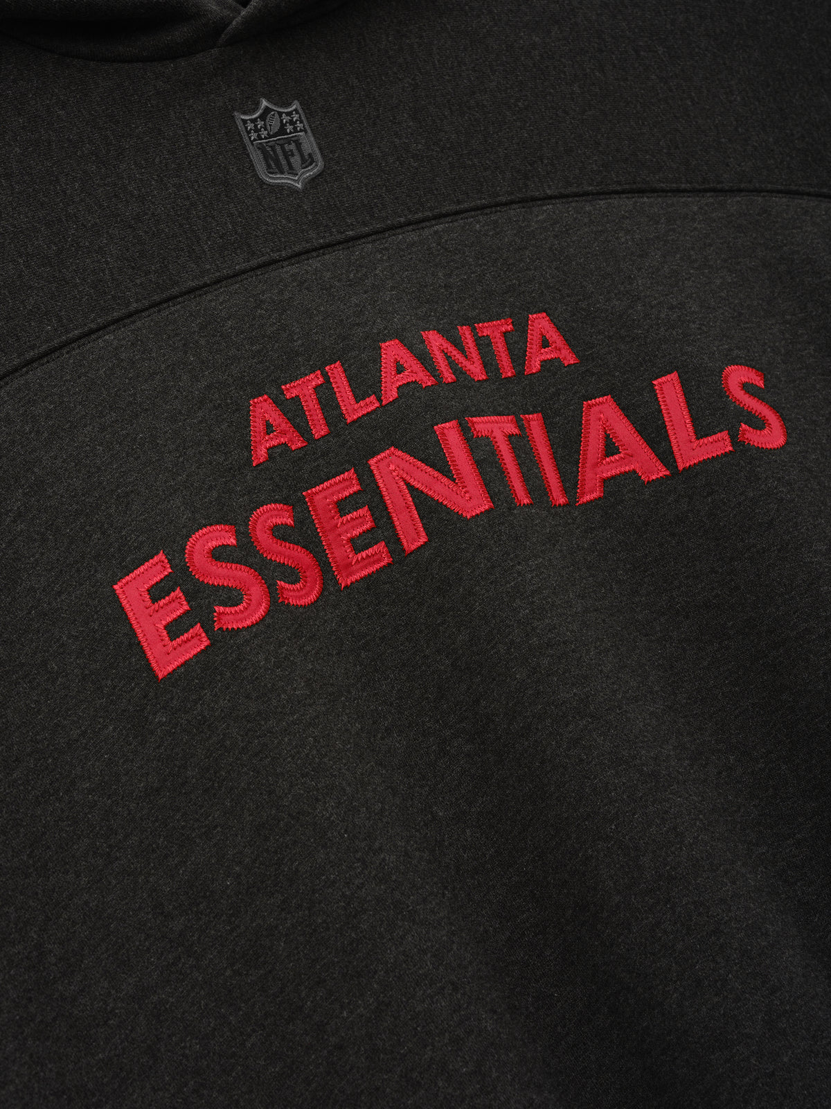Falcons 90s Relaxed Hoodie close up in black with red Atlanta Essentials lettering and NFL shield as a Tops product detail