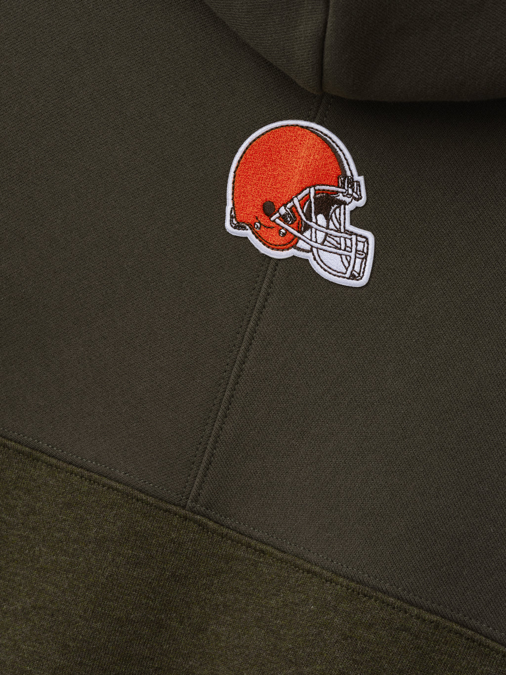 Browns 90s Relaxed Hoodie close up featuring an embroidered orange football helmet patch on dark brown fleece with tonal color blocking as a Tops product detail