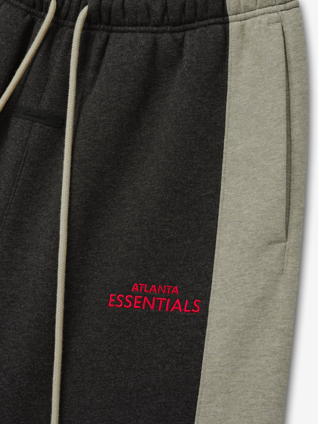 Falcons Lounge Sweatpant close up in black fleece with gray side panel cream drawstring and red Atlanta Essentials embroidery shown as a Bottoms product detail