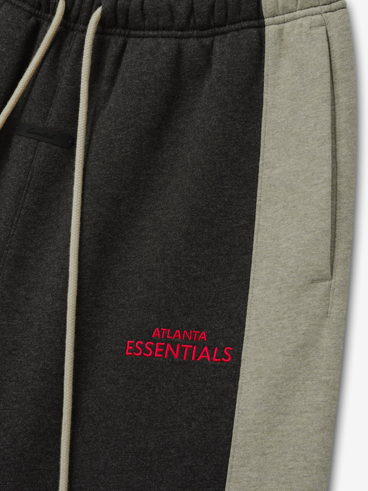 Falcons Lounge Sweatpant close up in black fleece with gray side panel cream drawstring and red Atlanta Essentials embroidery shown as a Bottoms product detail