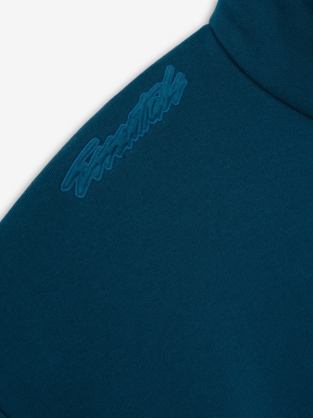 Classic Track Jacket in deep teal shown in close detail with tonal Fear of God shoulder embroidery and a structured stand collar as Outerwear