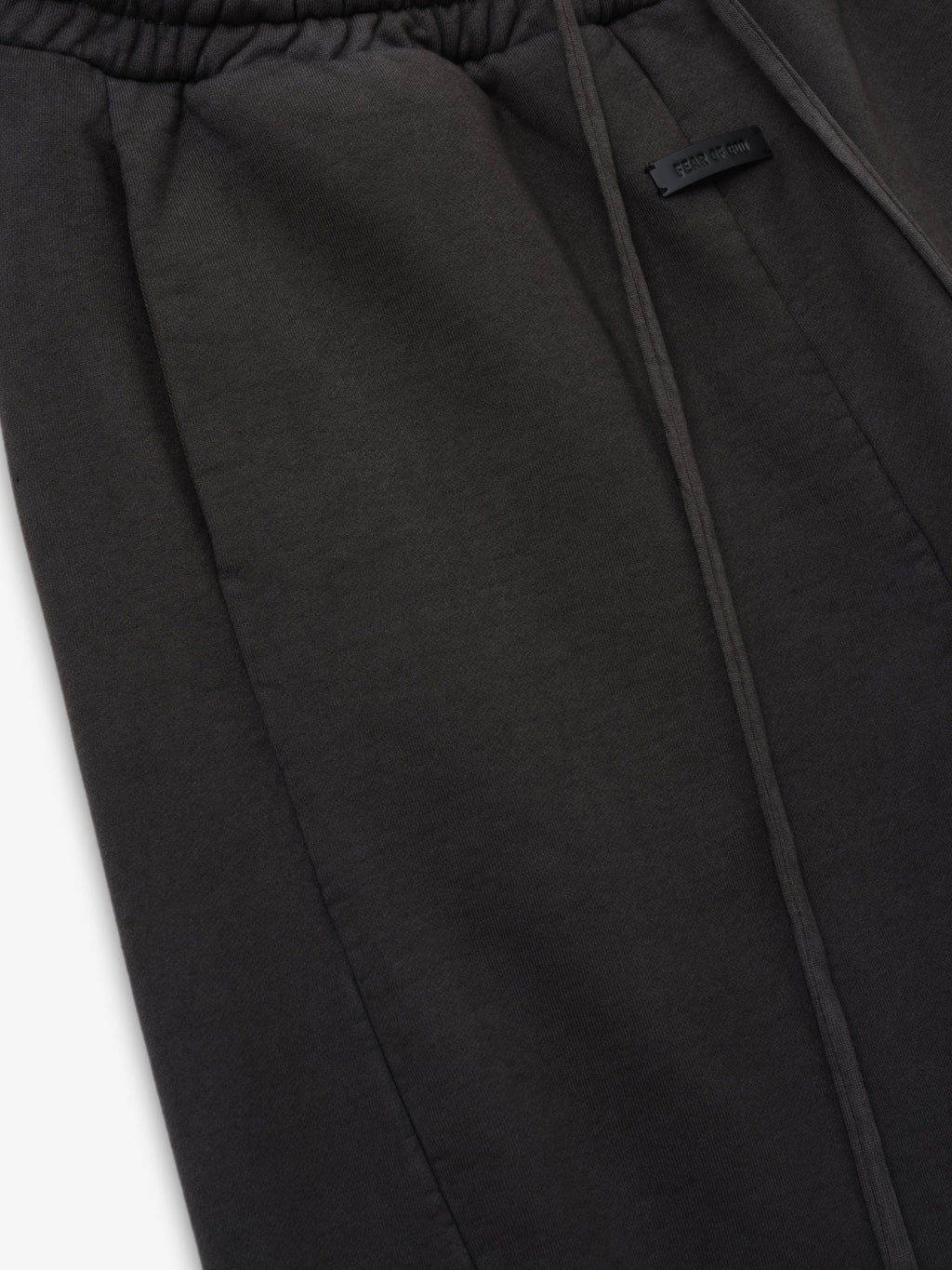 Engineered Sweatpants in black closeup showing the elastic waistband pocket seam and tonal branded label detail as Bottoms