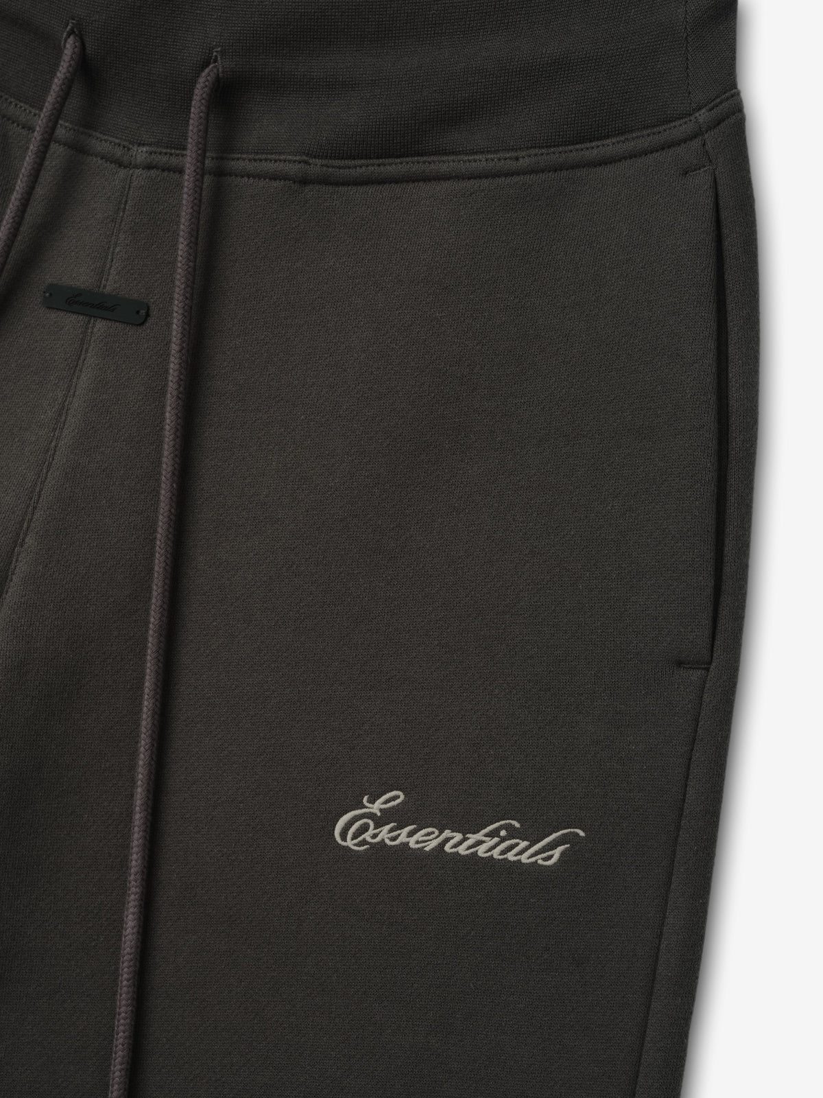 Womens Low Rise Sweatpant in black with drawstring waistband slanted side pocket and Essentials logo shown in close up as Bottoms