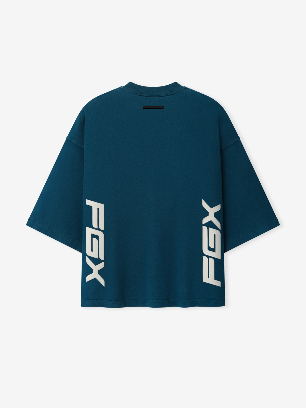Merch Tee in dark teal with white vertical PXG graphics near the lower front short sleeves and crew neckline displayed flat as Tops