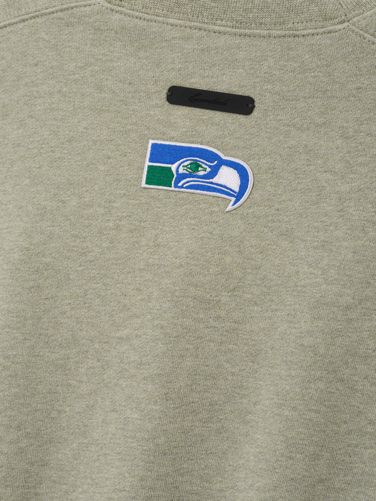 Seahawks 90s Relaxed Crewneck in sage green fleece with embroidered Seahawks logo and black chest label shown as a Tops product detail