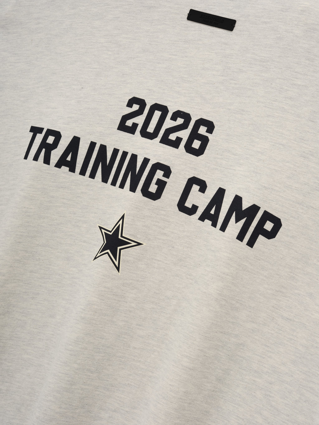 Dallas Cowboys Training Camp Tee in soft light heather fabric featuring bold black "2026 Training Camp" text and a star emblem, designed as a casual and sporty top.
