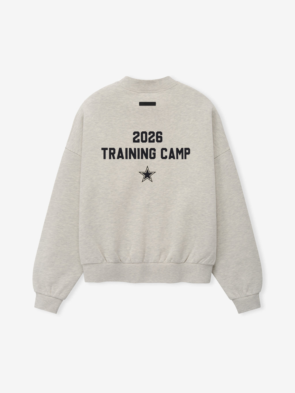 Dallas Cowboys Training Camp Crewneck Boxy Fit in light heather fabric showing the back with bold black "2026 Training Camp" text and star emblem, featuring a relaxed fit and dropped shoulders.