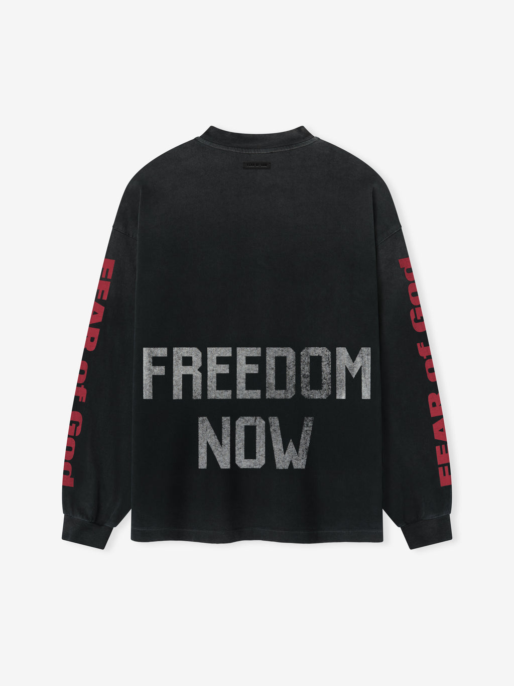 Freedom Relaxed Long Sleeve Tee in black featuring large gray “FREEDOM NOW” text on the back and bold red “FEAR OF GOD” lettering printed vertically down both sleeves, crafted from soft cotton for a comfortable tops option.