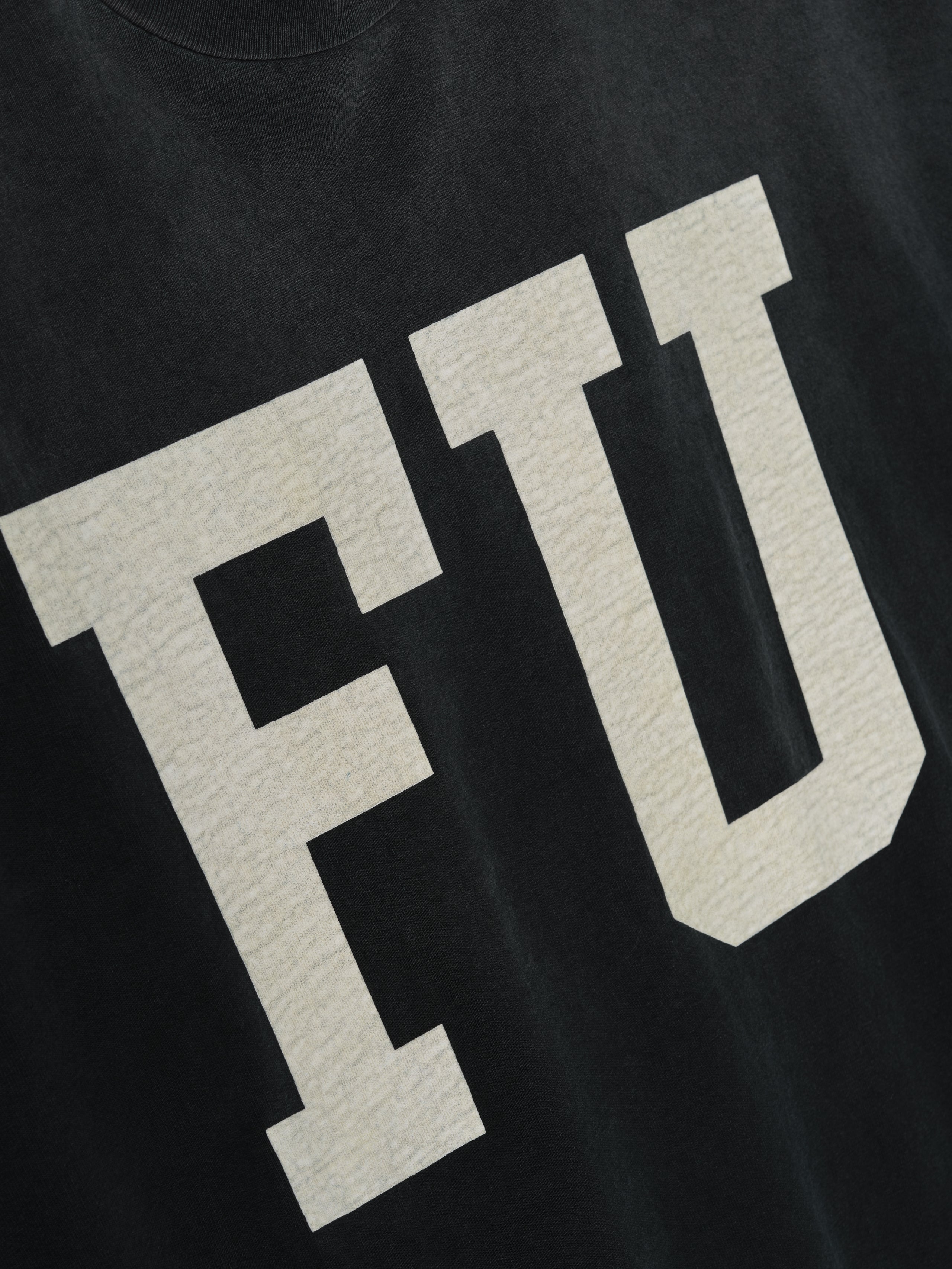 Freedom Relaxed Long Sleeve Tee in black with large textured cream “FU” letters on the front, crafted from soft cotton for a comfortable and casual tops choice.