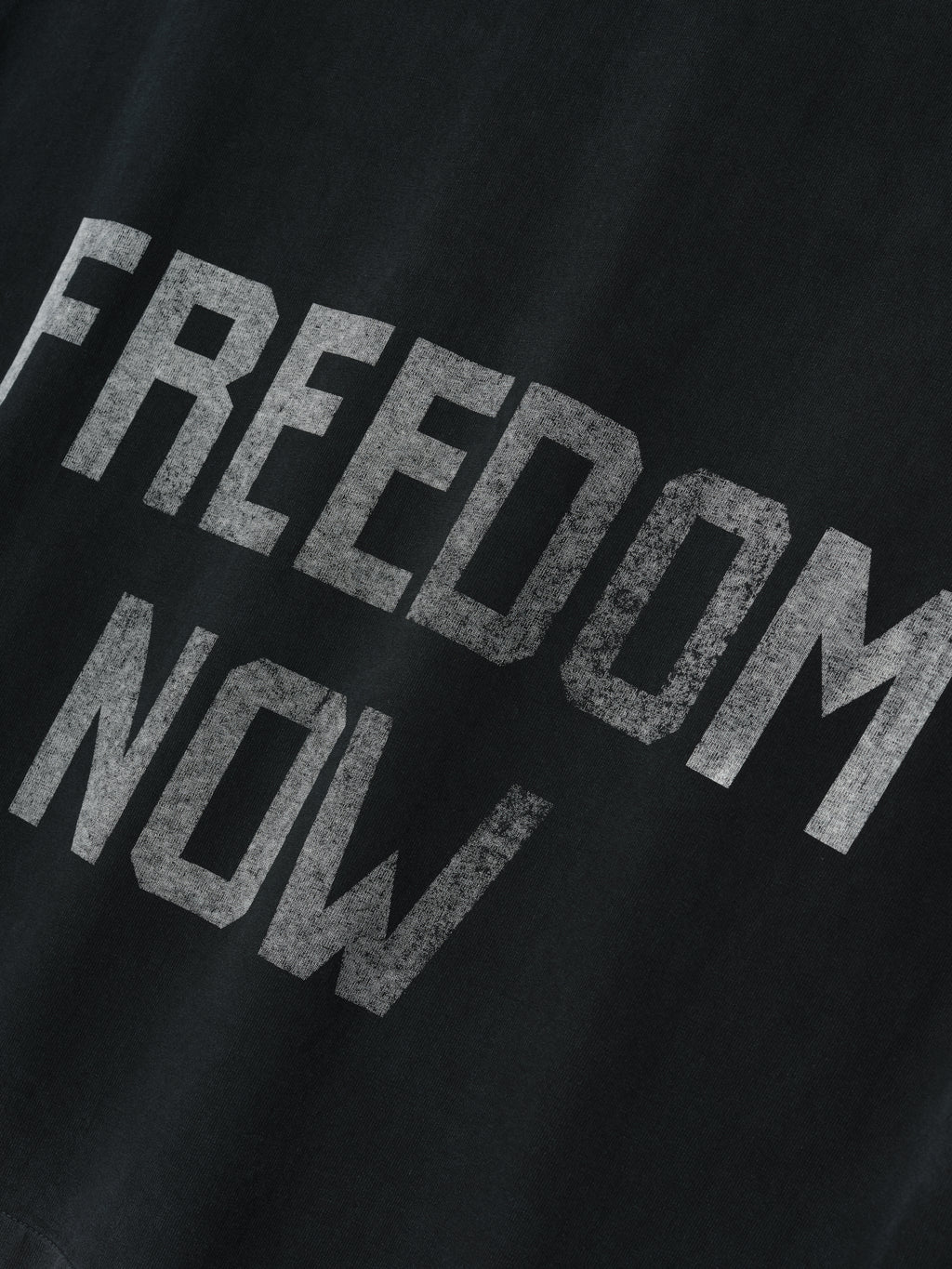 Freedom Relaxed Long Sleeve Tee in black with distressed white “FREEDOM NOW” lettering printed on soft cotton fabric, offering a relaxed fit for casual tops styling.