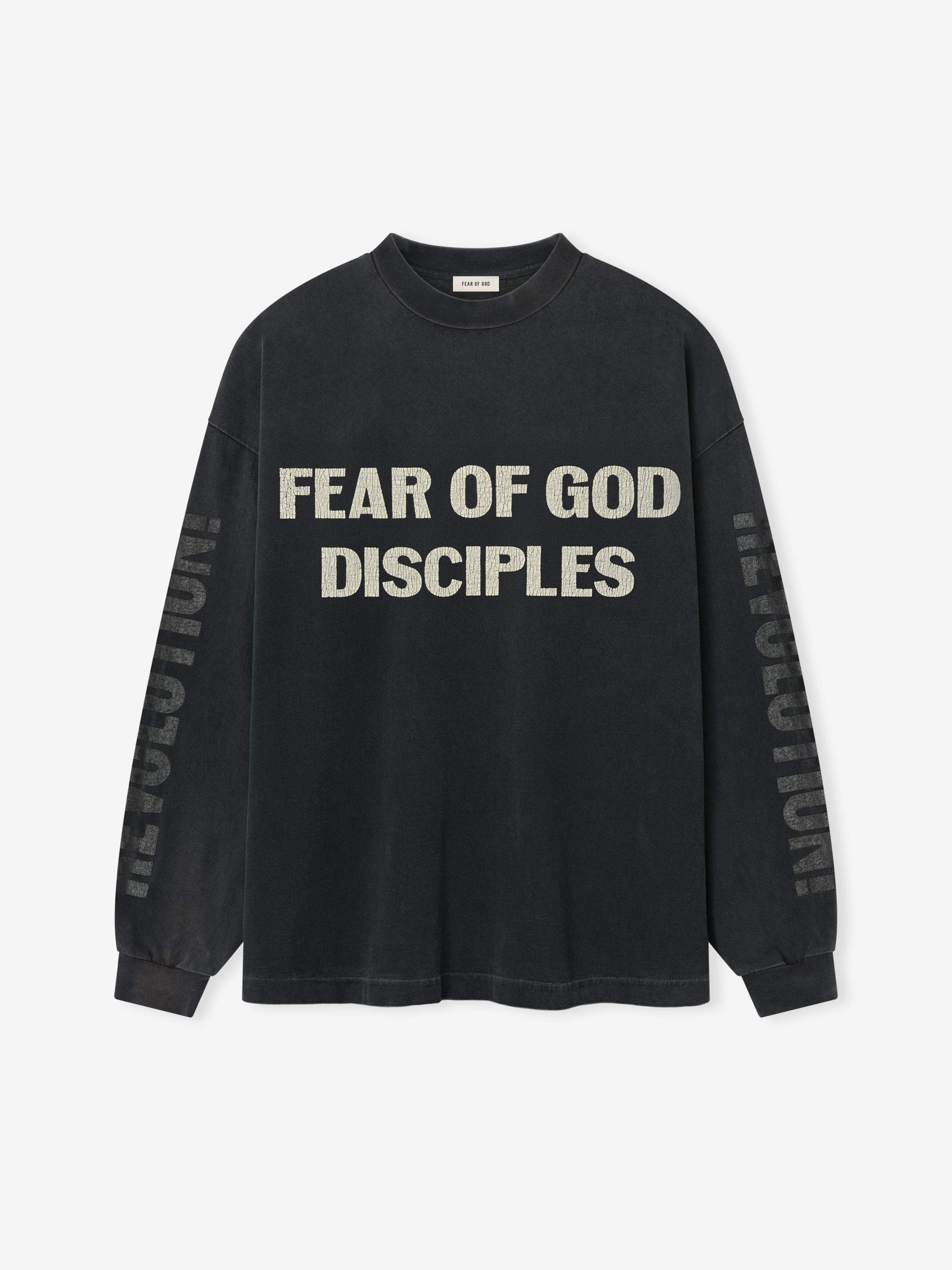 Disciple Relaxed Long Sleeve Tee in faded black featuring bold distressed “FEAR OF GOD DISCIPLES” text across the chest and subtle “REVOLUTION” lettering down the sleeves, crafted for casual tops wear.