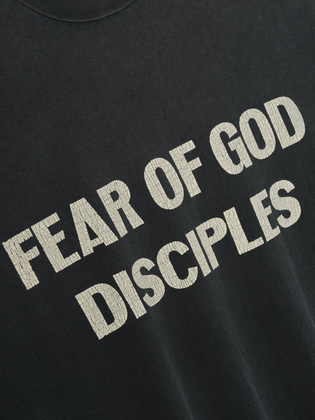 Disciple Relaxed Long Sleeve Tee in black featuring bold textured cream “FEAR OF GOD DISCIPLES” text across the chest, crafted from soft cotton for stylish casual tops wear.