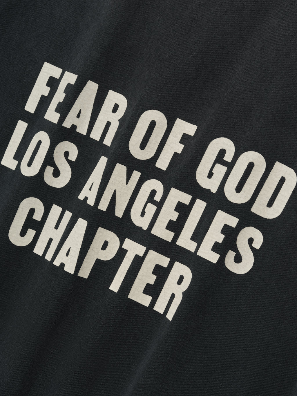 Disciple Relaxed Long Sleeve Tee in black showcasing bold cream “FEAR OF GOD LOS ANGELES CHAPTER” text printed in large letters, crafted from soft cotton for casual tops wear.