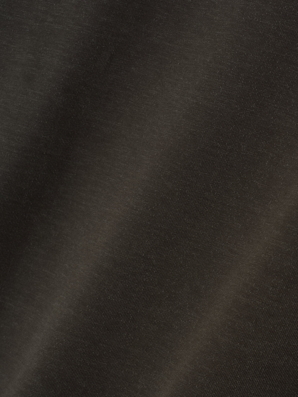 Detailed close-up of off-black fabric texture showcasing the smooth weave and subtle sheen of the Cotton Viscose Relaxed Tee material.