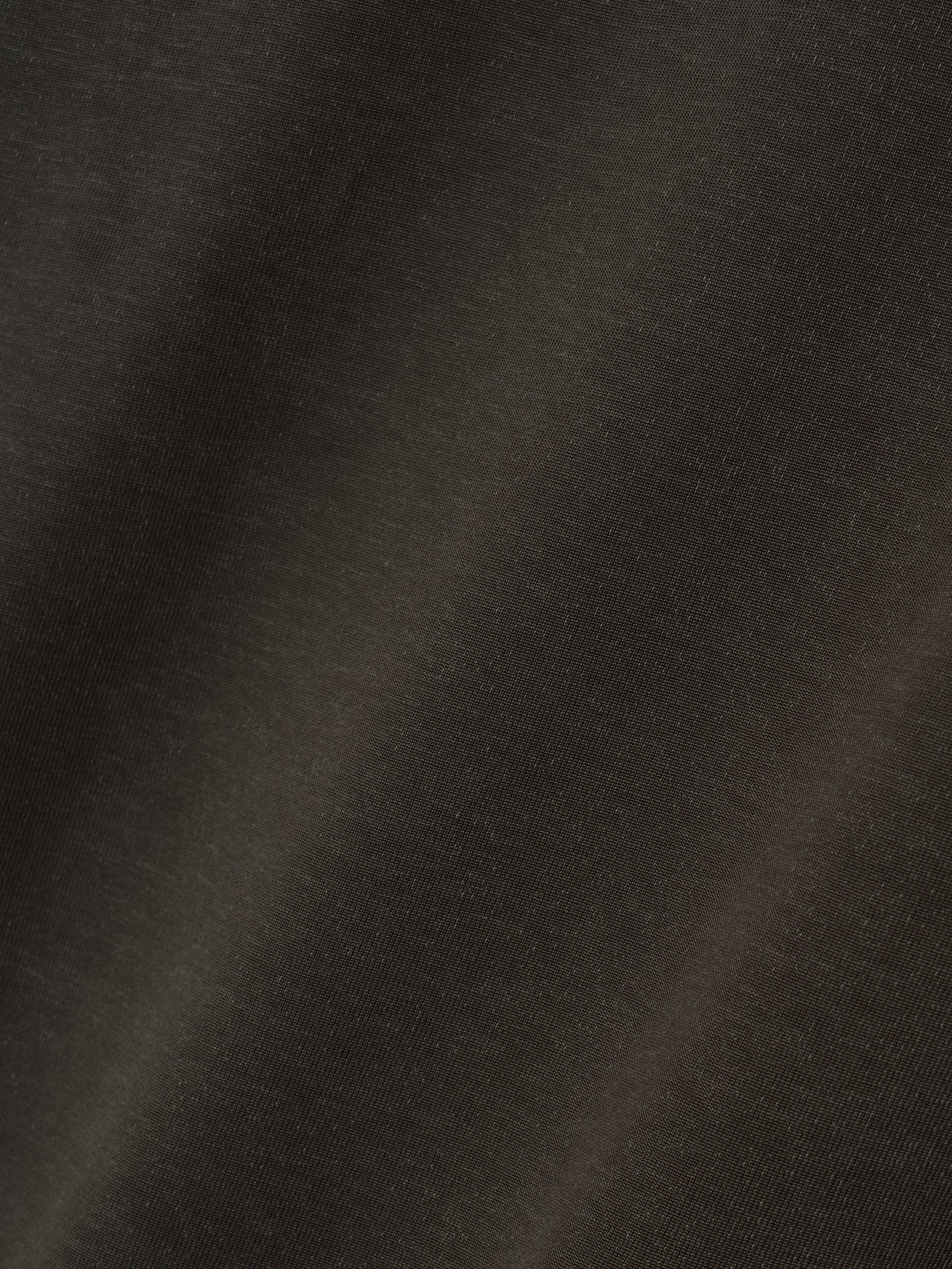 Detailed close-up of off-black fabric texture showcasing the smooth weave and subtle sheen of the Cotton Viscose Relaxed Tee material.