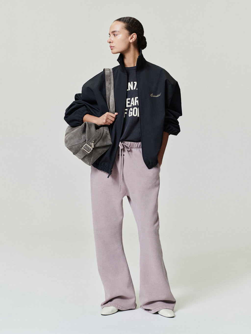 woman wearing relaxed fit flare sweatpants in washed vintage mauve with elastic drawstring waistband