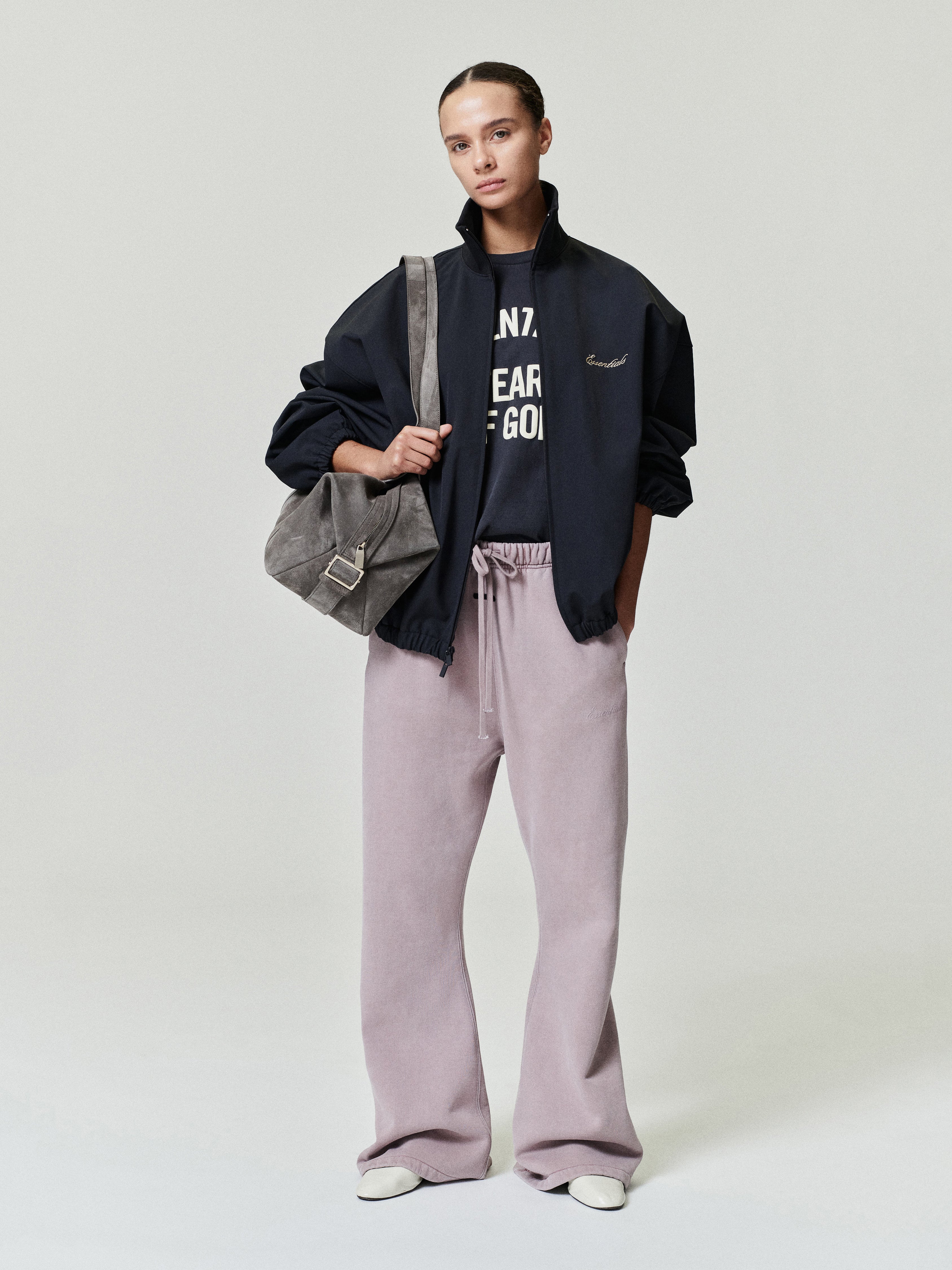 woman wearing relaxed fit flare sweatpants in vintage pigment-dyed cotton fleece with elastic drawstring waist