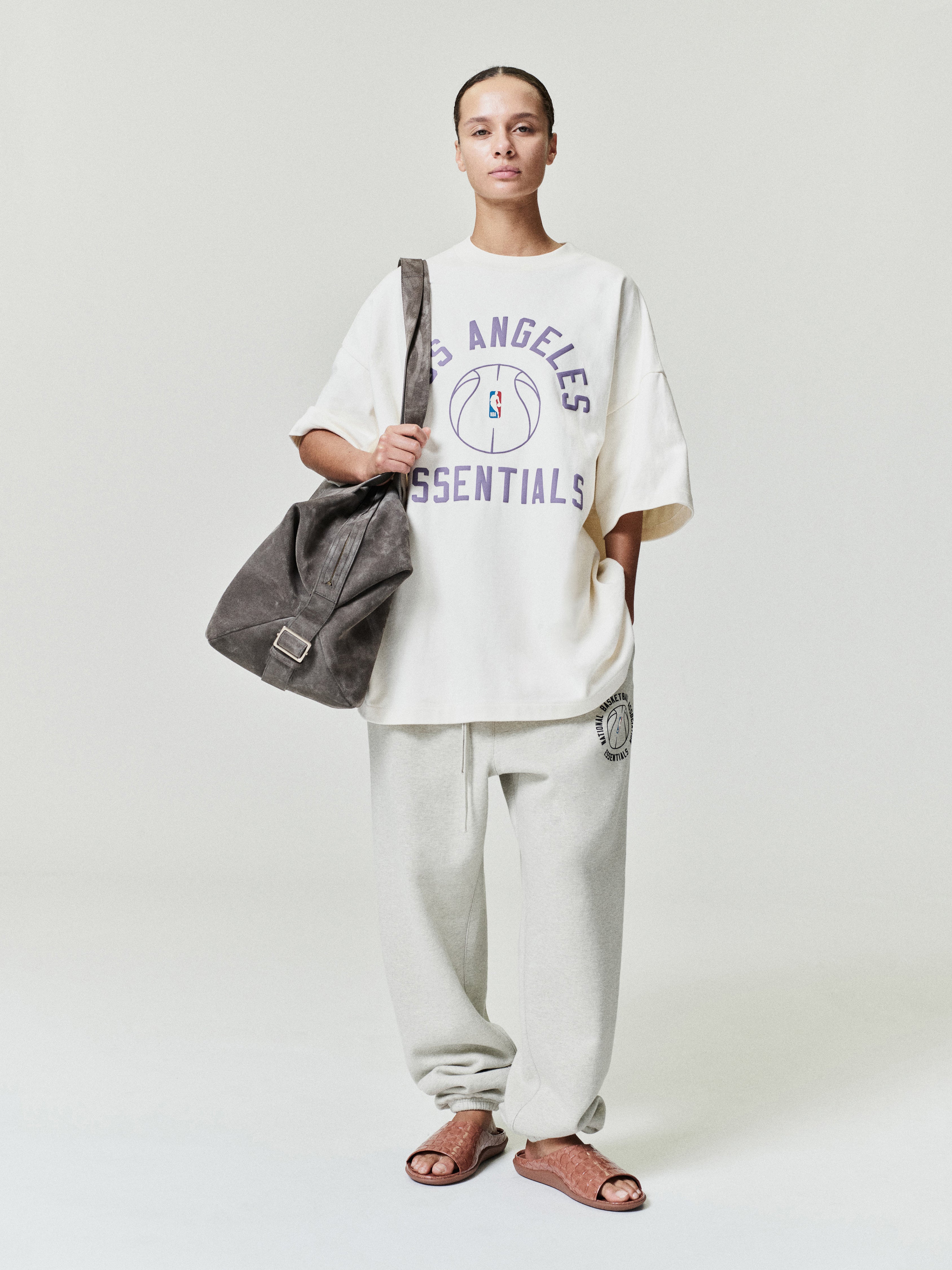 model wearing off-white heavyweight fleece sweatpant with elastic cuffs and NBA x Barkley Hendricks circular logo on thigh